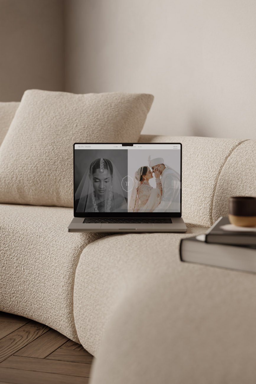 wedding photographer website mock up in laptop on a cream sofa