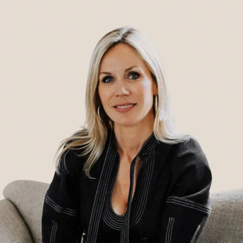 blonde lady interior designer sitting on a sofa