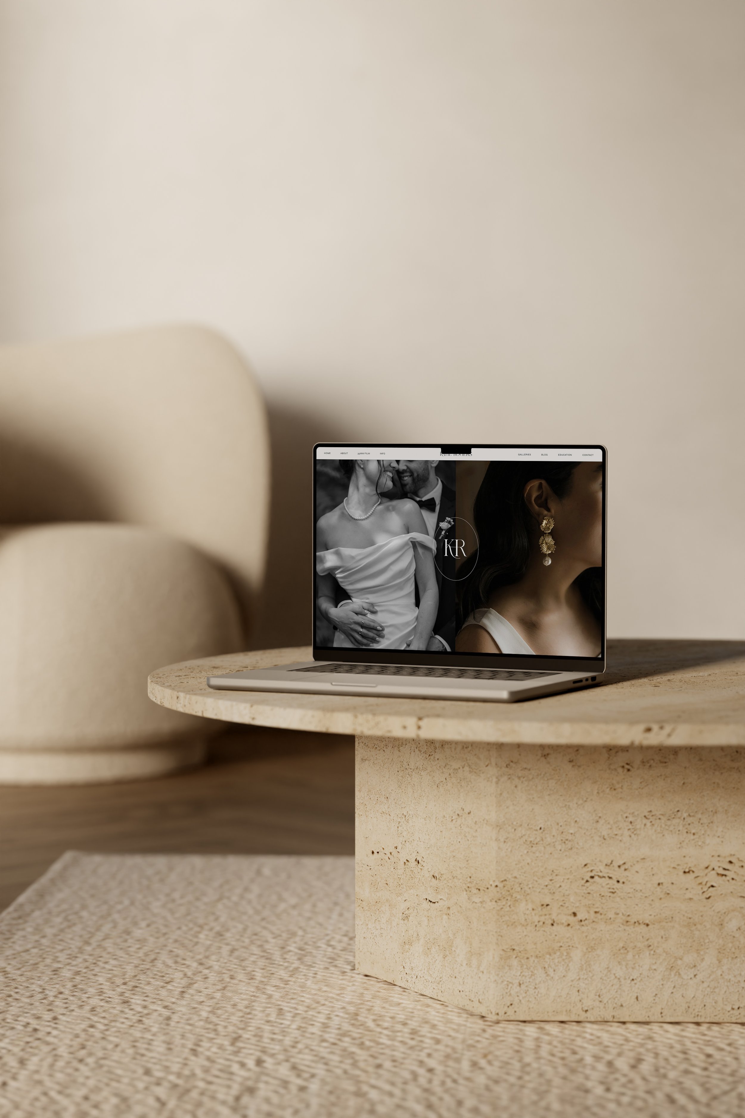 Laptop mockup of a Squarespace website for a wedding photographer, on a marble table
