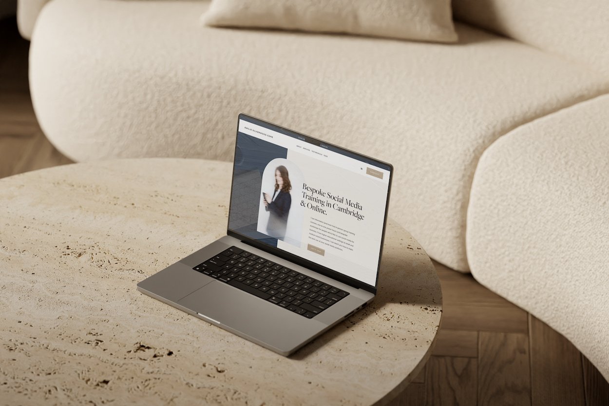 squarespace website mock up on a beige marble table in front of a cream sofa