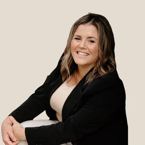 female wedding planner in black blazer smiling to camera