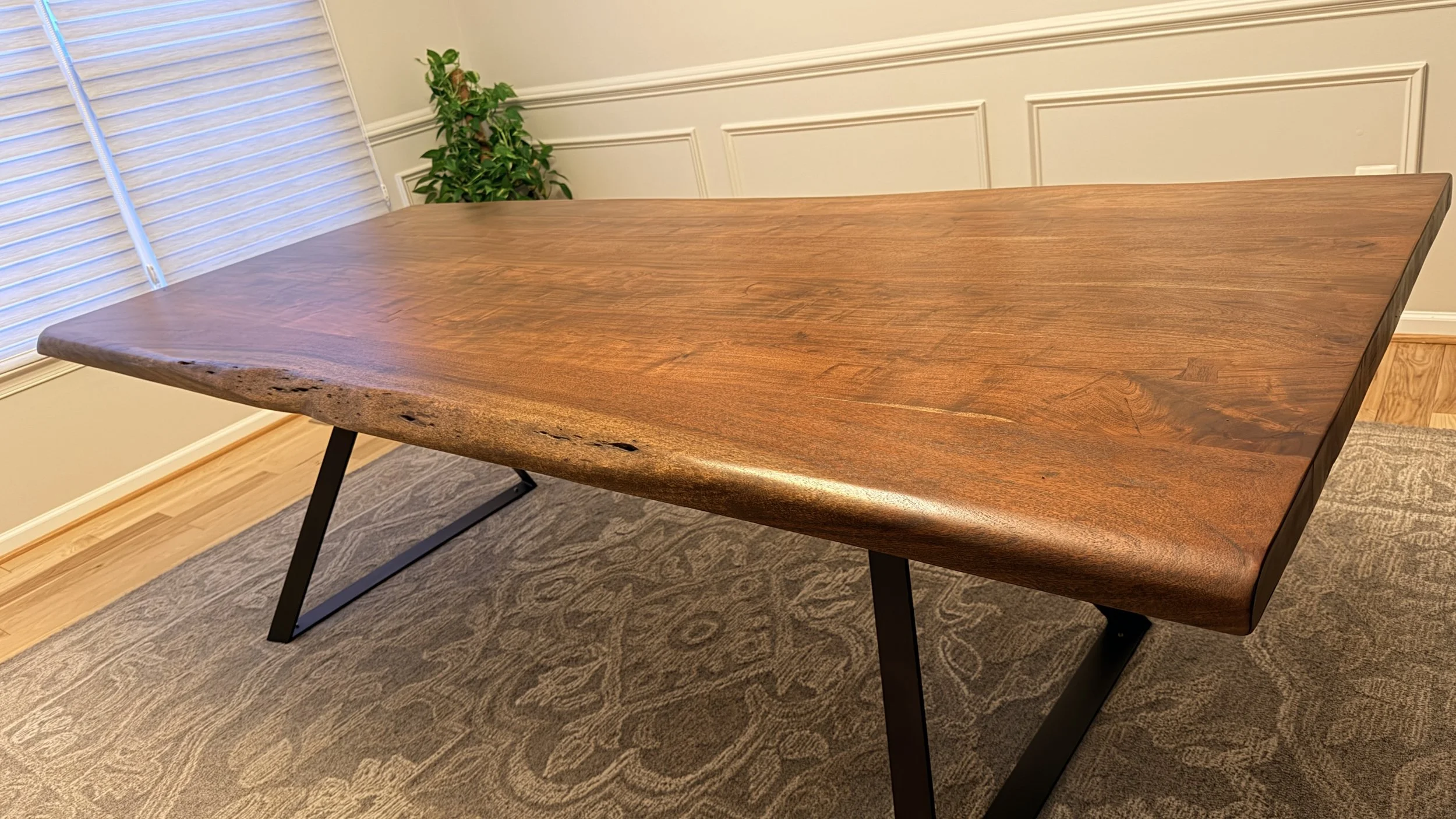 A statement live edge table by GrainStories: reclaimed hardwood, hand-finished warmth, and a sleek steel base, made to gather for decades.