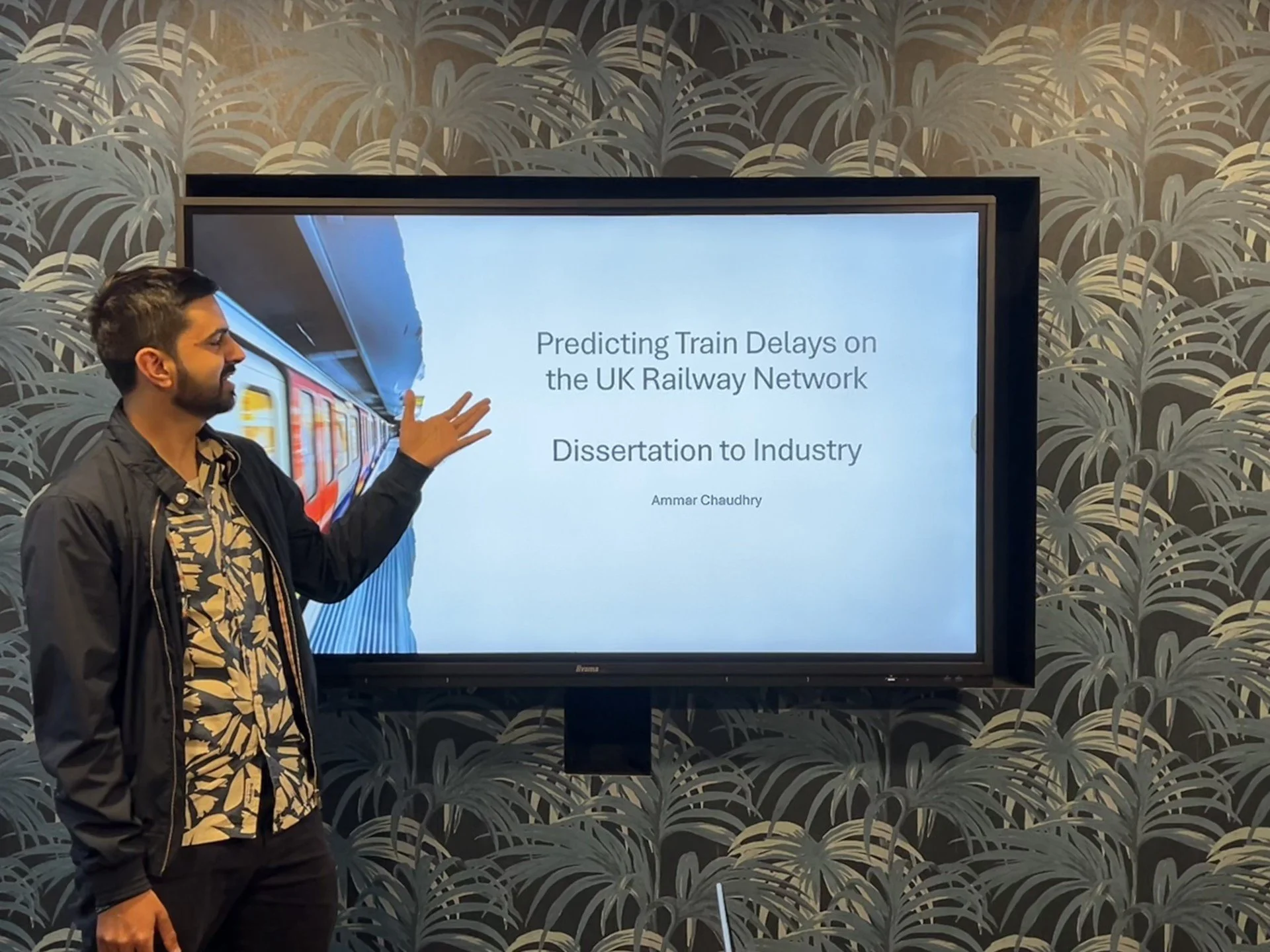 Image of Ammar (author of blog post) standing next to his presentation