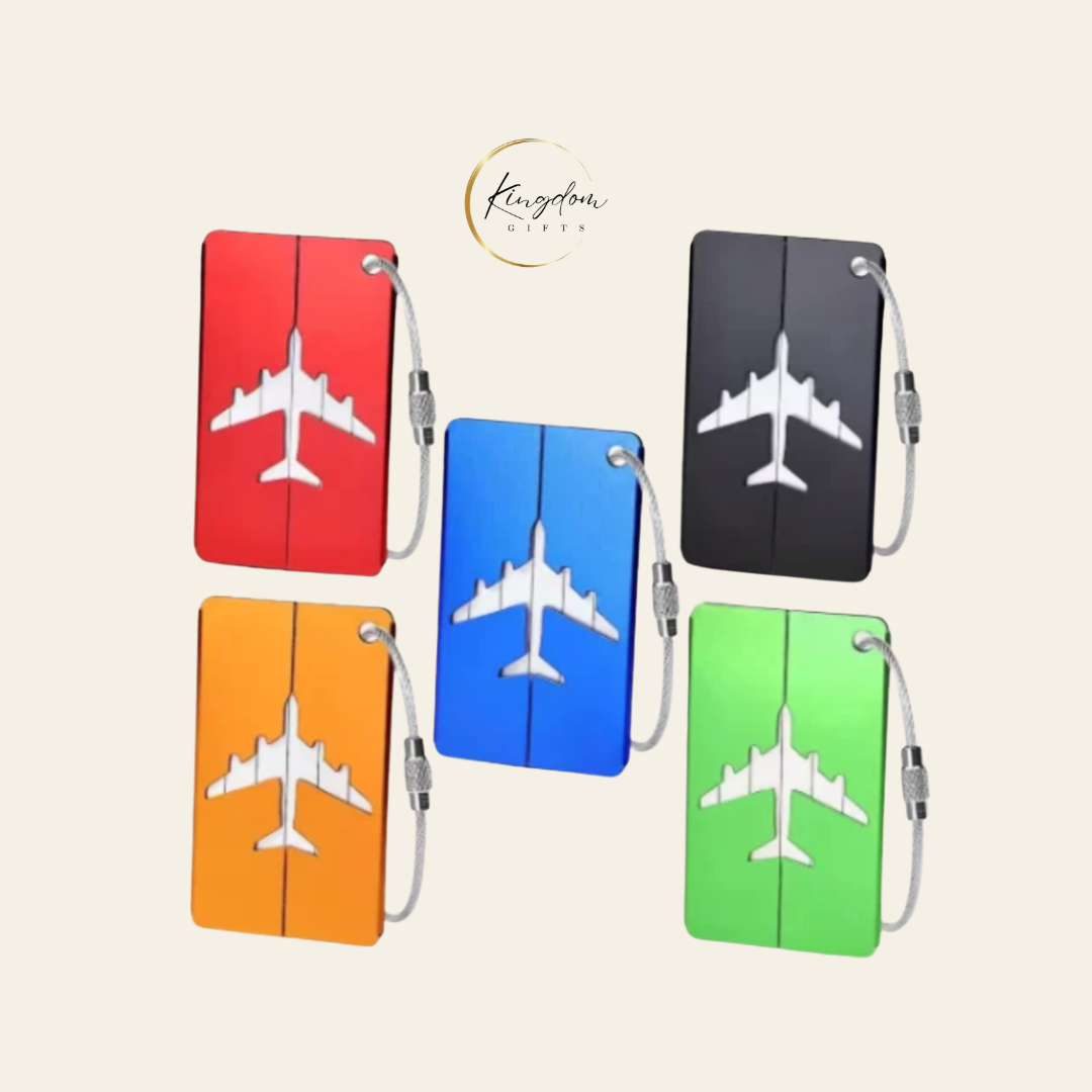 Assorted custom aluminium luggage tags in bulk with airplane cutout, available in red, blue, green, black, and orange for event giveaways.