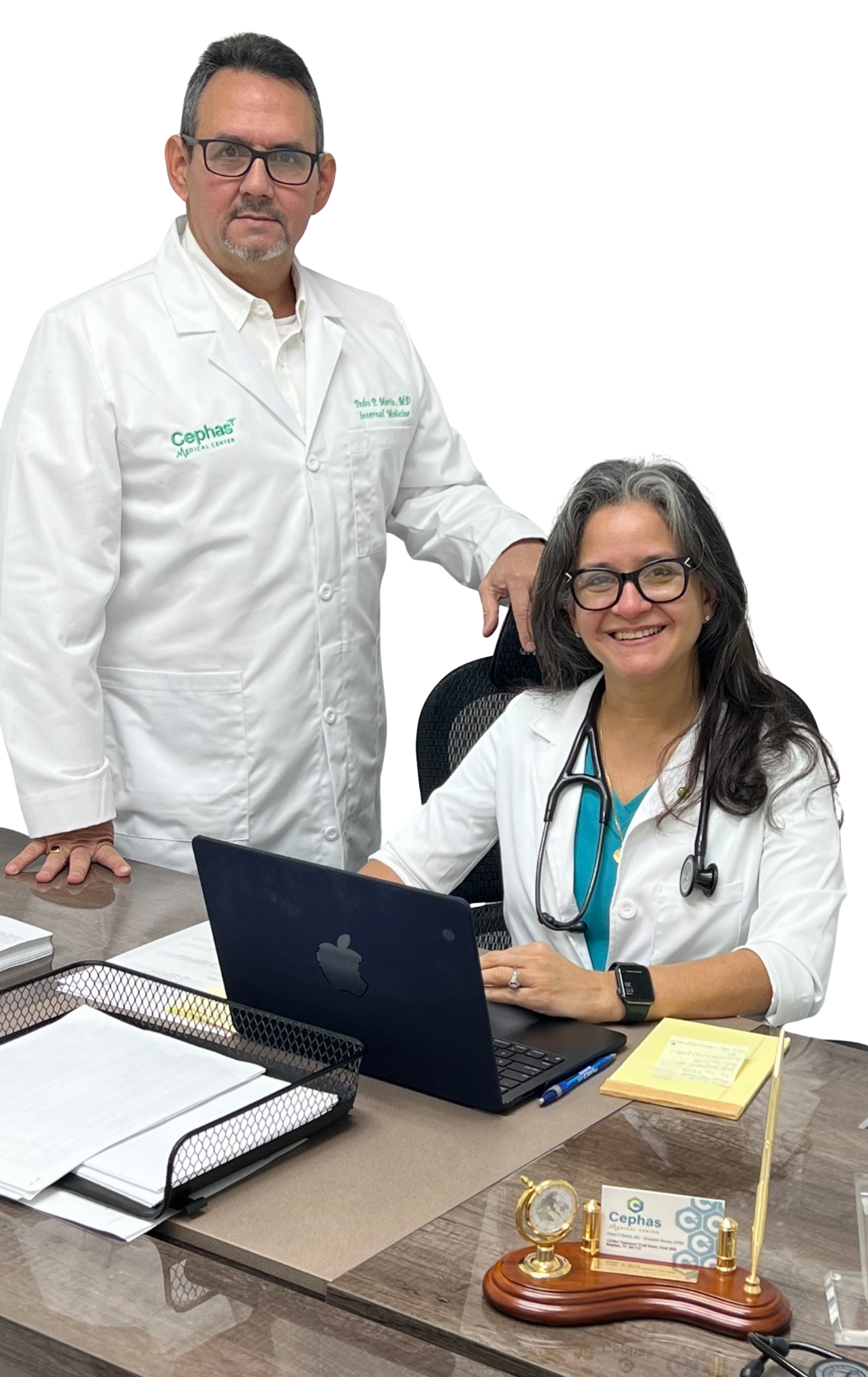 Physician and nurse practitioner in white coats at Cephas Medical Center reviewing patient information on a laptop in a clinical office.