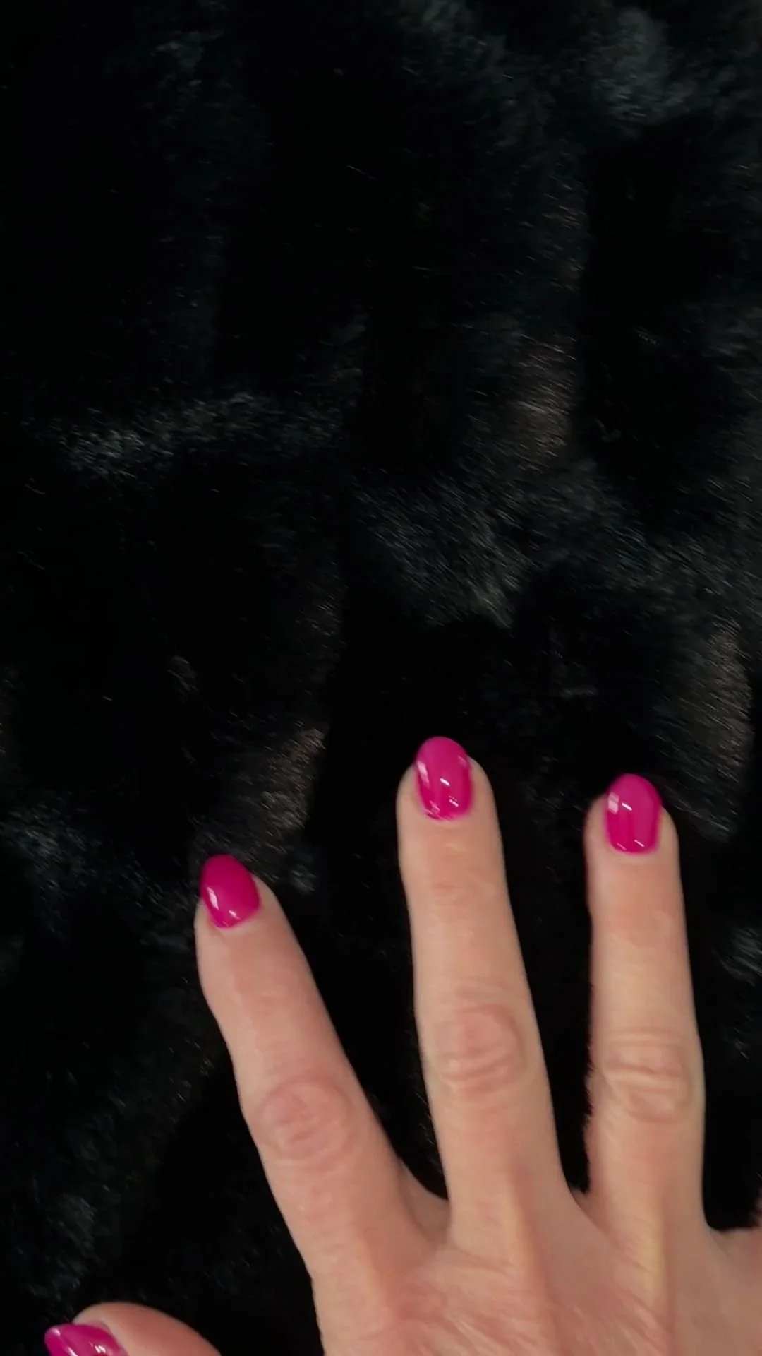 2.jpeg A hand with pink manicured nails resting on the Midnight Mink fur, highlighting the density and softness of the fibers.