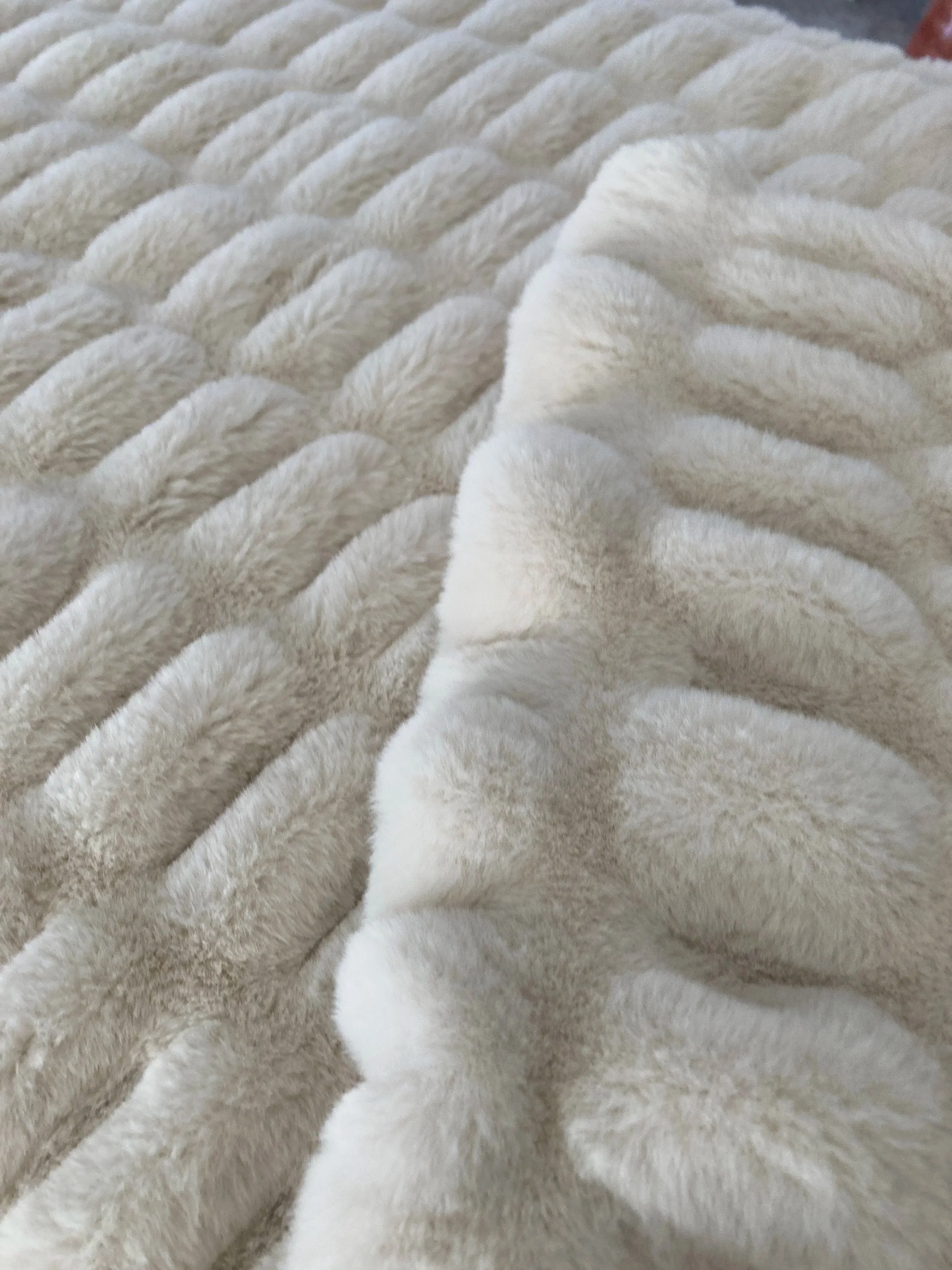 IMG_3618.jpg: A detailed close-up showing the thick, plush ridges and the folded edge of the ivory-white Natural Wonder Milan blanket.
