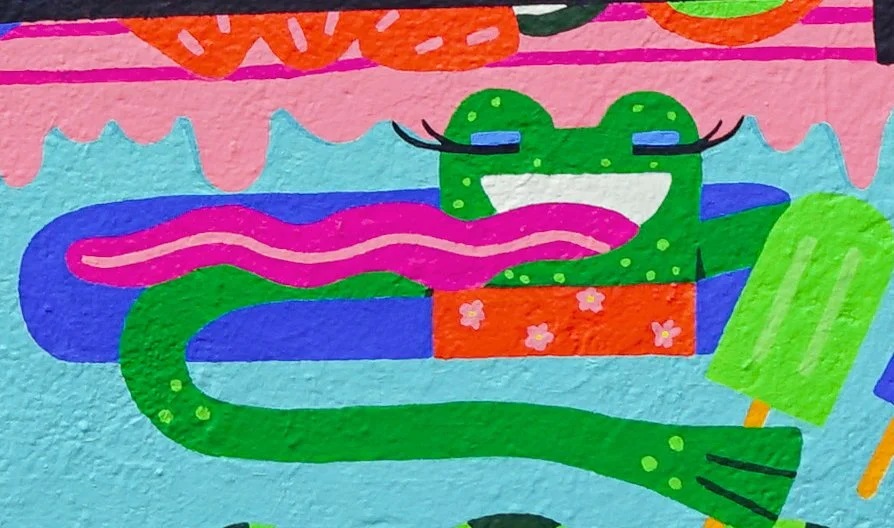 Colorful illustration of a smiling green crocodile with closed eyes, a long pink tongue, and decorated with flowers, set against a vibrant background of pink, orange, blue, and green elements.