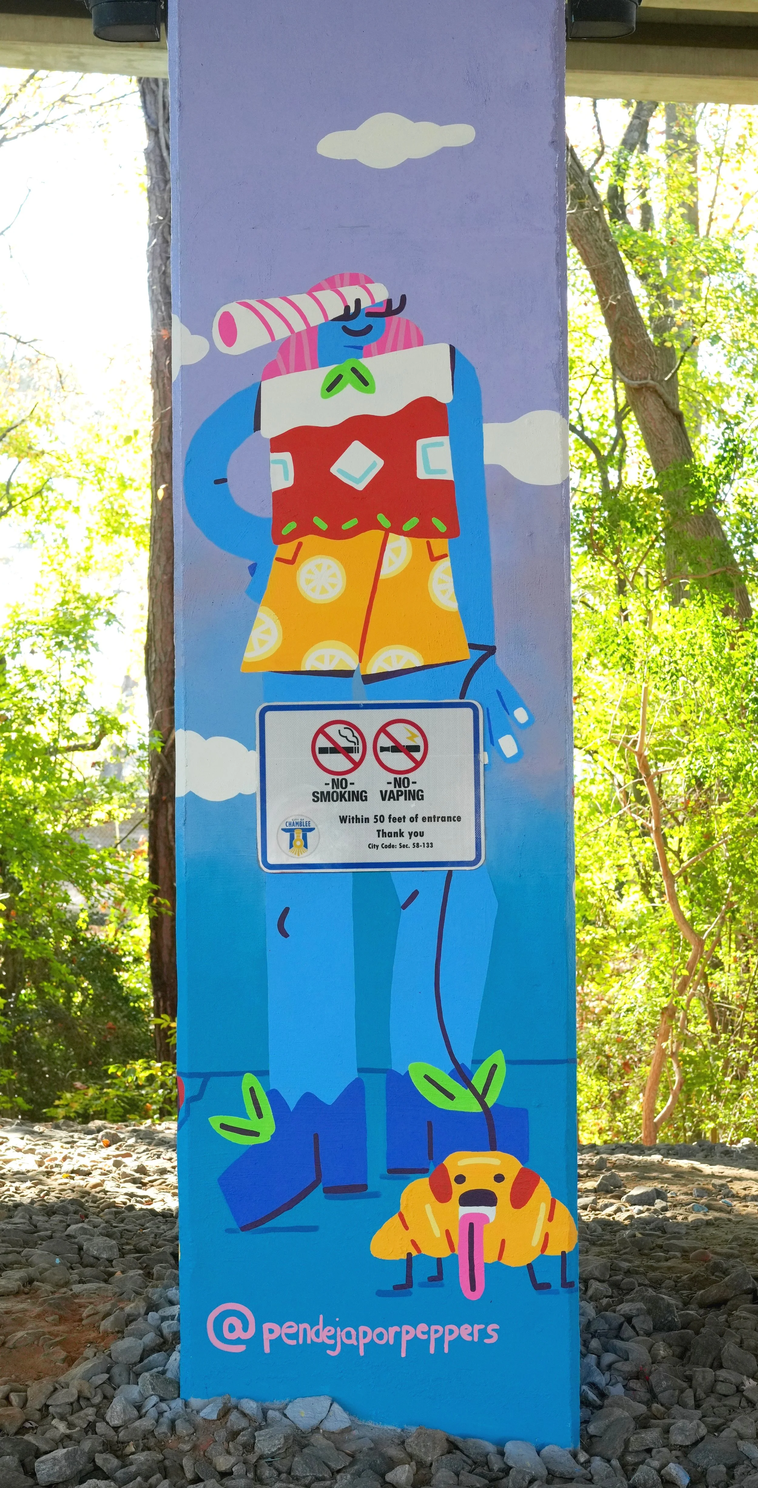 Colorful mural of a cartoon person with a snorkel and fins, wearing lemon-patterned shorts, standing in a natural outdoor setting with trees, and a stylized dog with a tongue sticking out at the bottom, with the Instagram handle @pendejaporpeppers at the bottom.