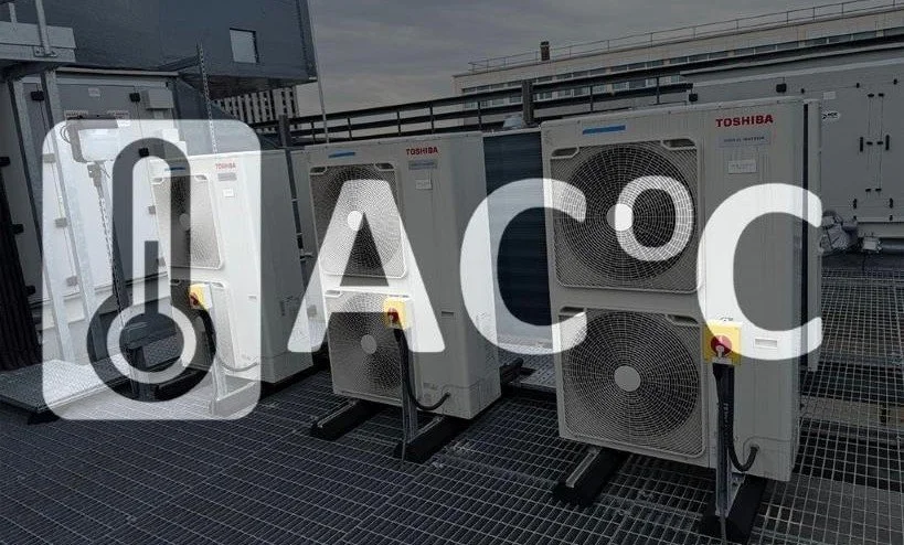 Several large Toshiba industrial air conditioning units installed on a metal rooftop, with a cloudy sky in the background.