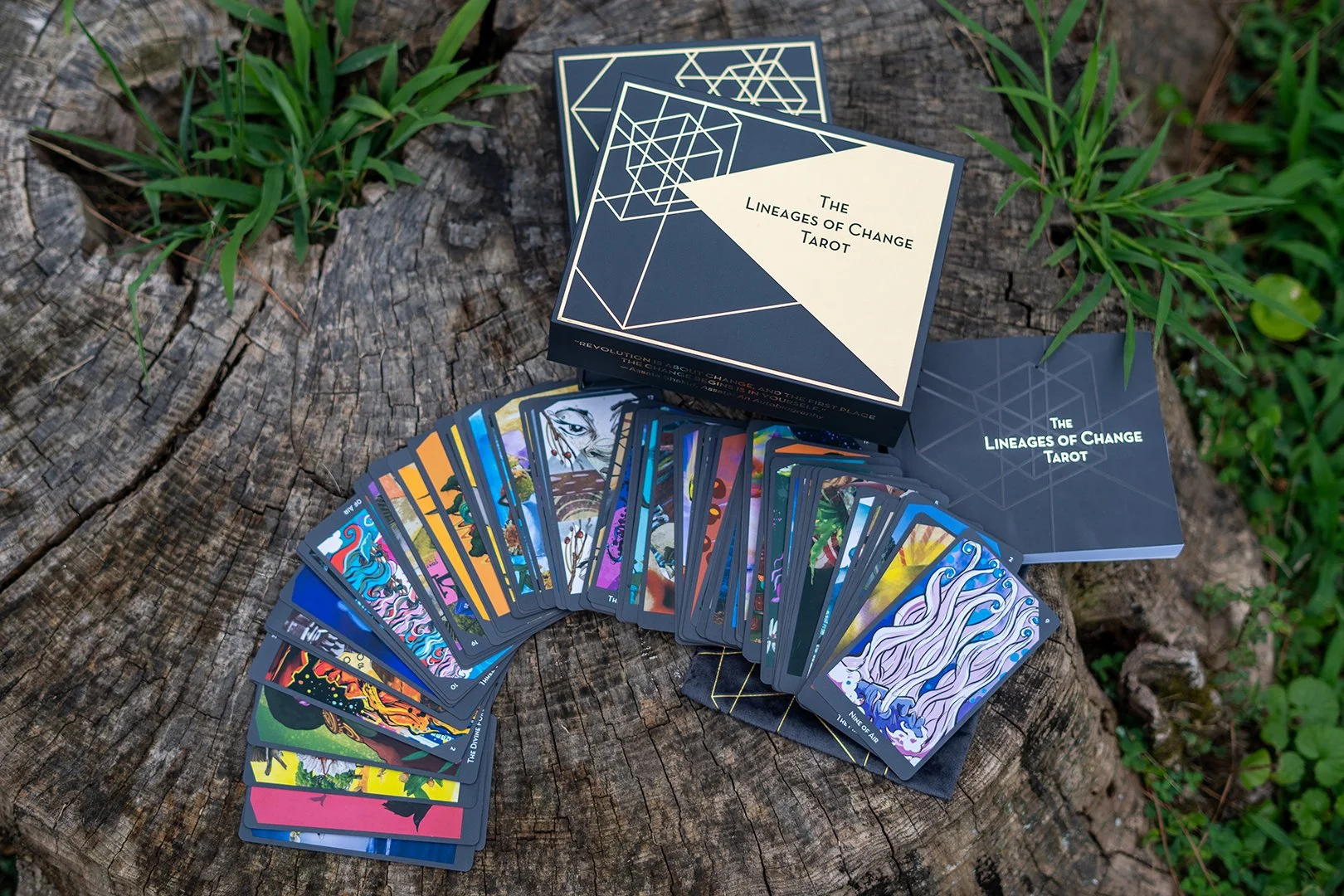 Box for the Lineages of Change Tarot deck, featuring vibrant green leaves, pink flowers, and stylized yellow plants set against a dark background with elegant white and gold typography.