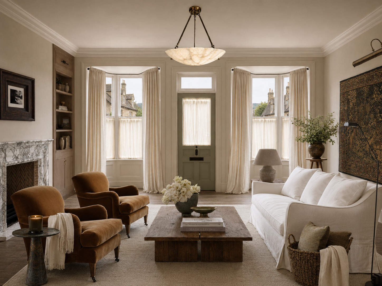 Reception room designed by VCO Studio, with ochre armchairs, a white sofa and original architectural details.