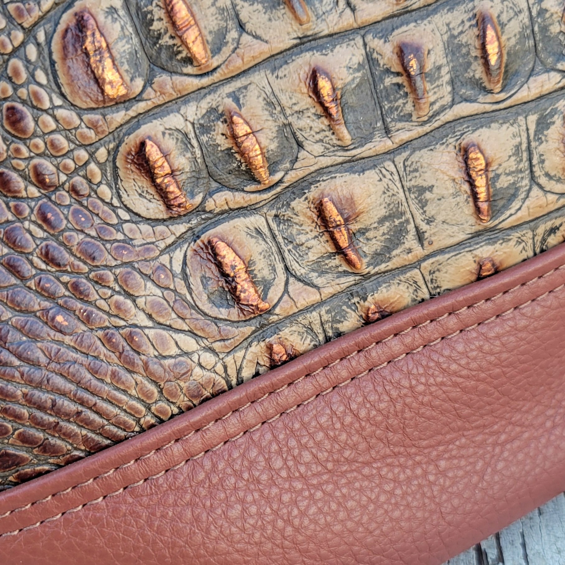 Turned edges give this mini leather tote extra polish