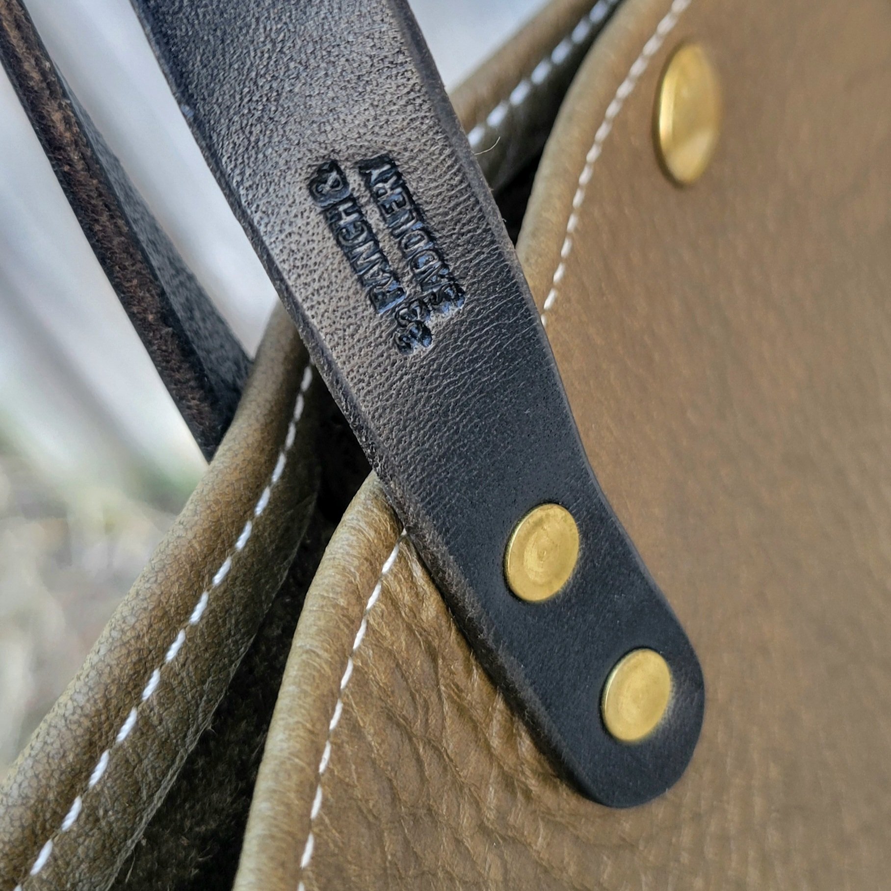 Maker stamp on a handmade leather mini tote bag