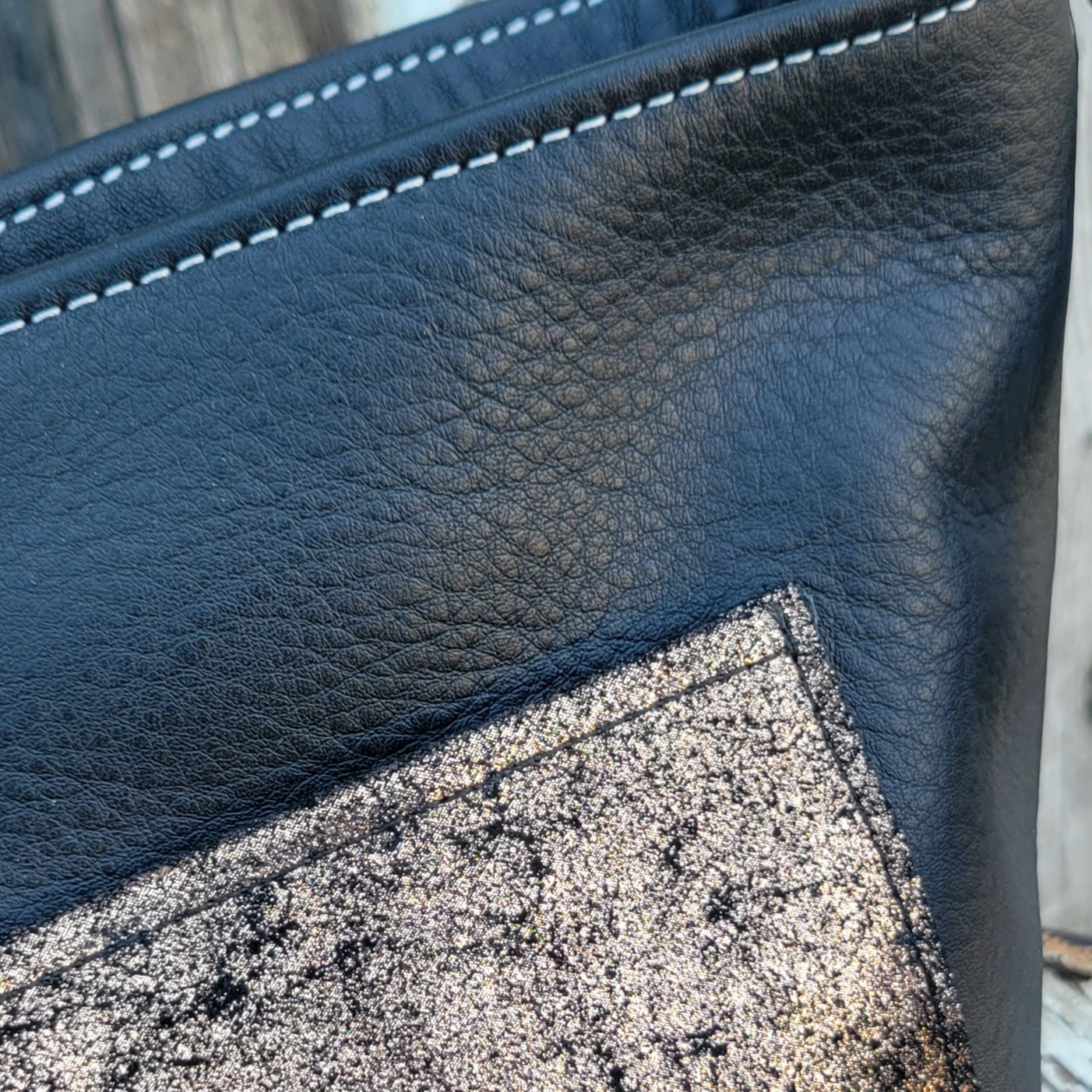 Mini leather bucket bag features turned edges for a polished look