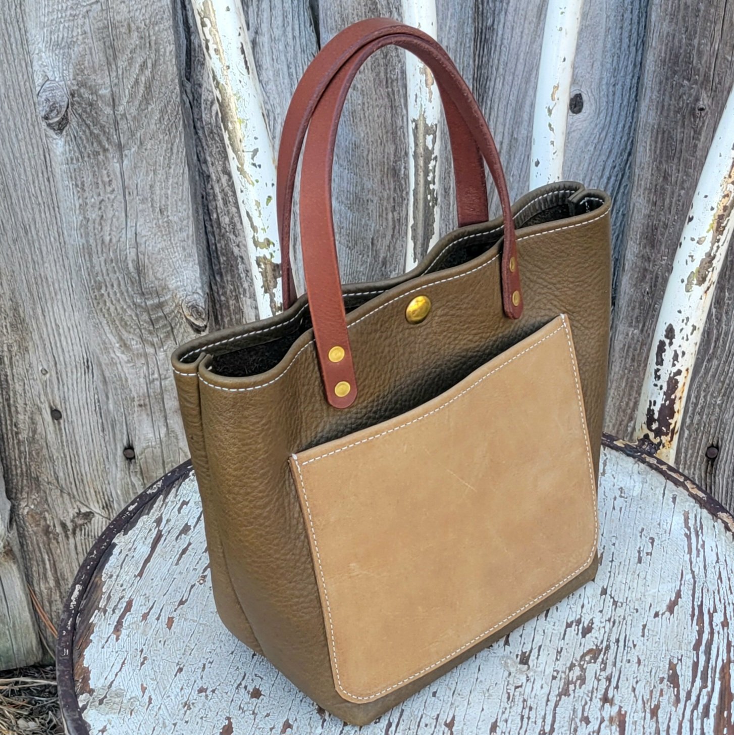 Mini leather tote in a carefree olive and tan colorway