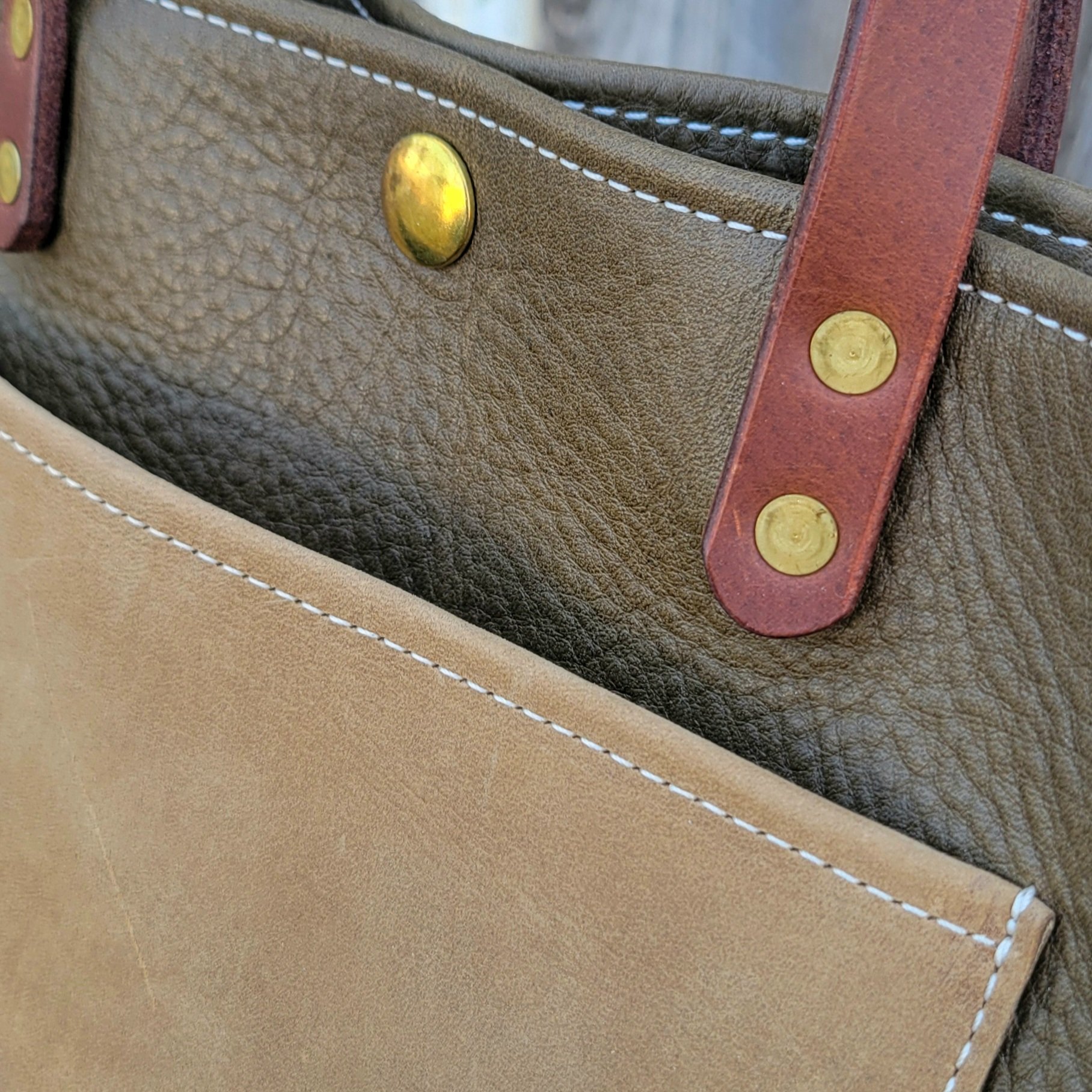 Turned leather edges give this mini tote a polished finish