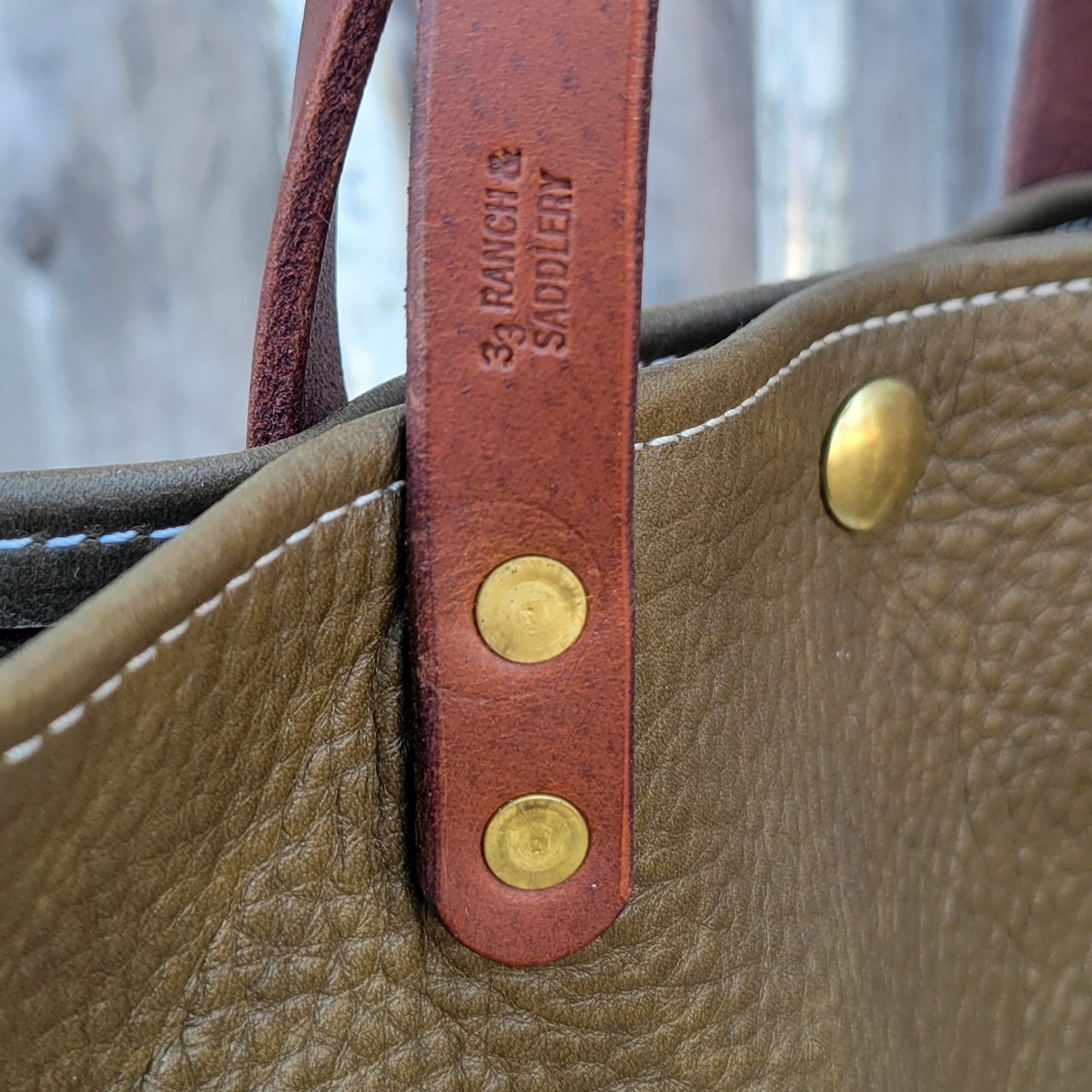Solid brass hardware and maker stamp on the olive mini tote