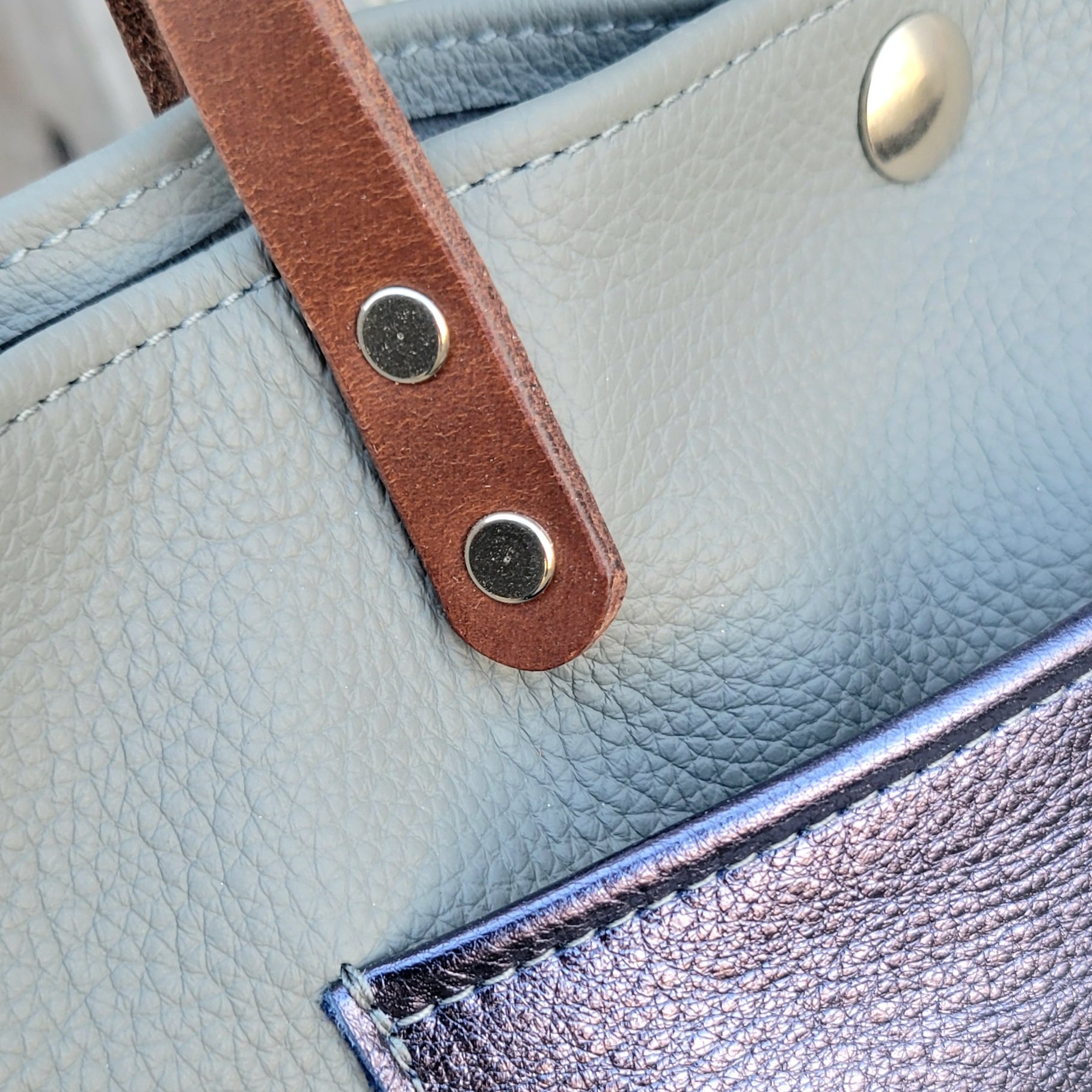 Sturdy water buffalo leather straps on a mini tote bag