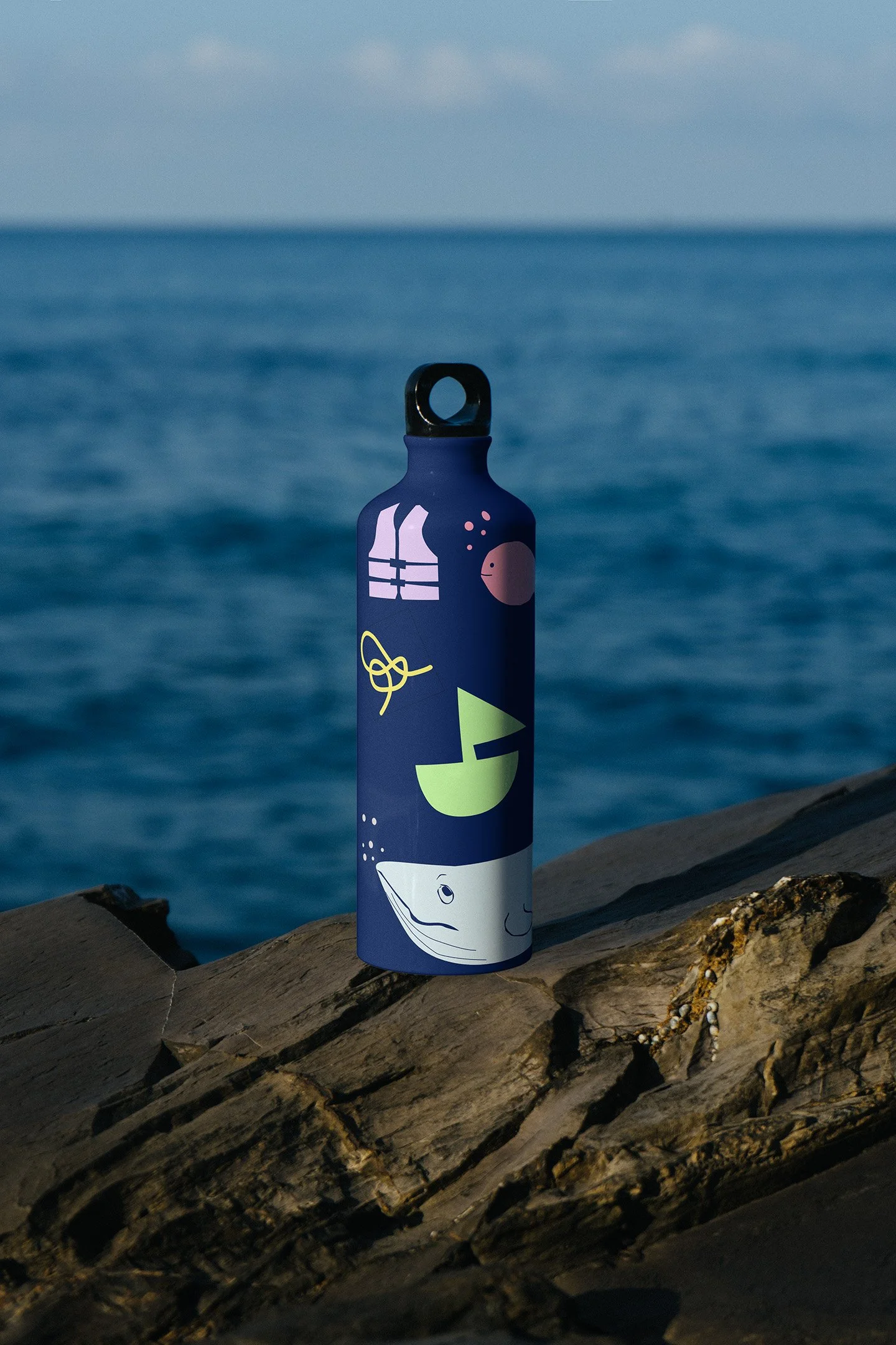 A metal flask/bottle with branded illustrations on it
