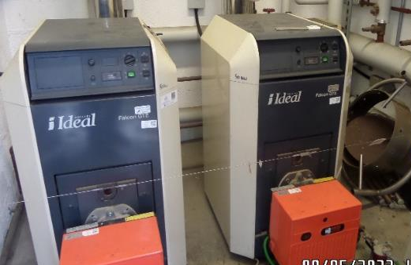 Two industrial water treatment or filtration machines labeled 'Ideal Falcon3 ST' in a utility room, with a small orange device in front of each machine.