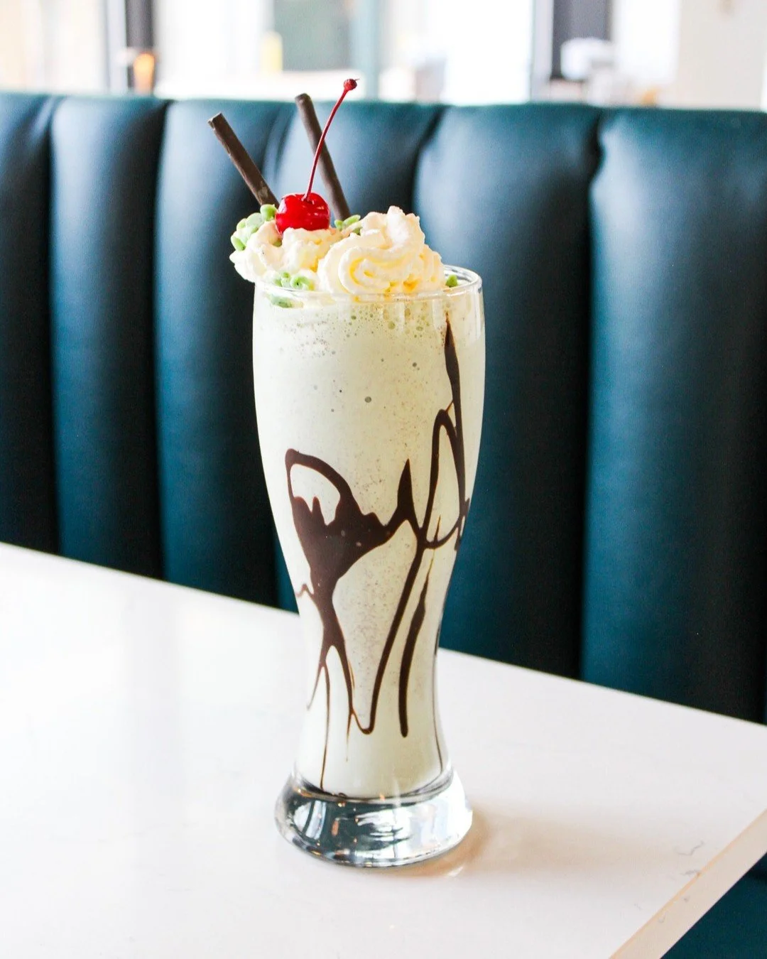 Our Grasshopper Boozy shake is a smash hit. 

It features our mint chocolate chip ice cream blended with peppermint schnapps and chocolate liqueur. We top it with chocolate mint sticks, mint chips, hot fudge, whipped cream and a cherry.

Enjoy one fo