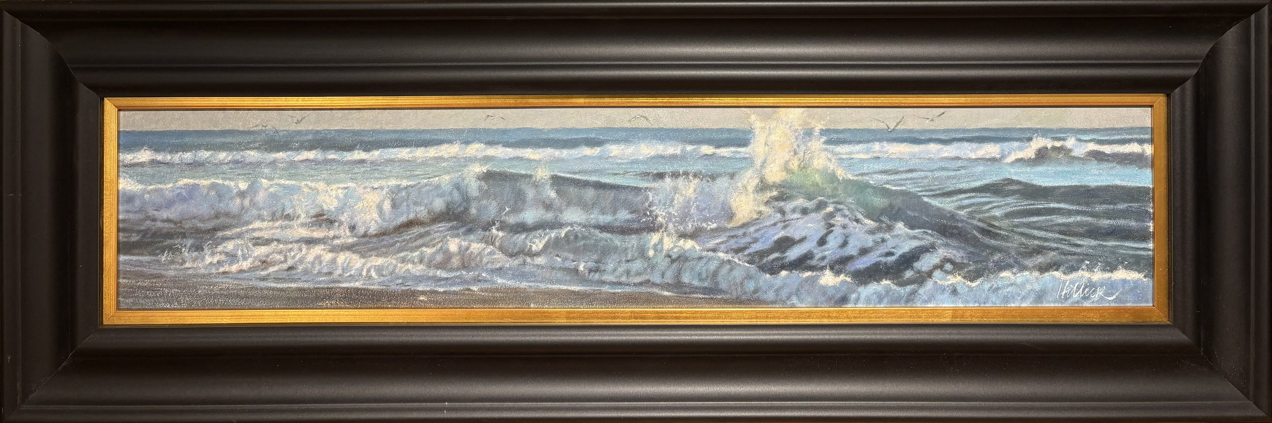 Matthew Hillier oil painting titled Morning Light 6x30 $3500 of breaking waves on the beach with sea foam and birds pictured in a black frame with gold liner