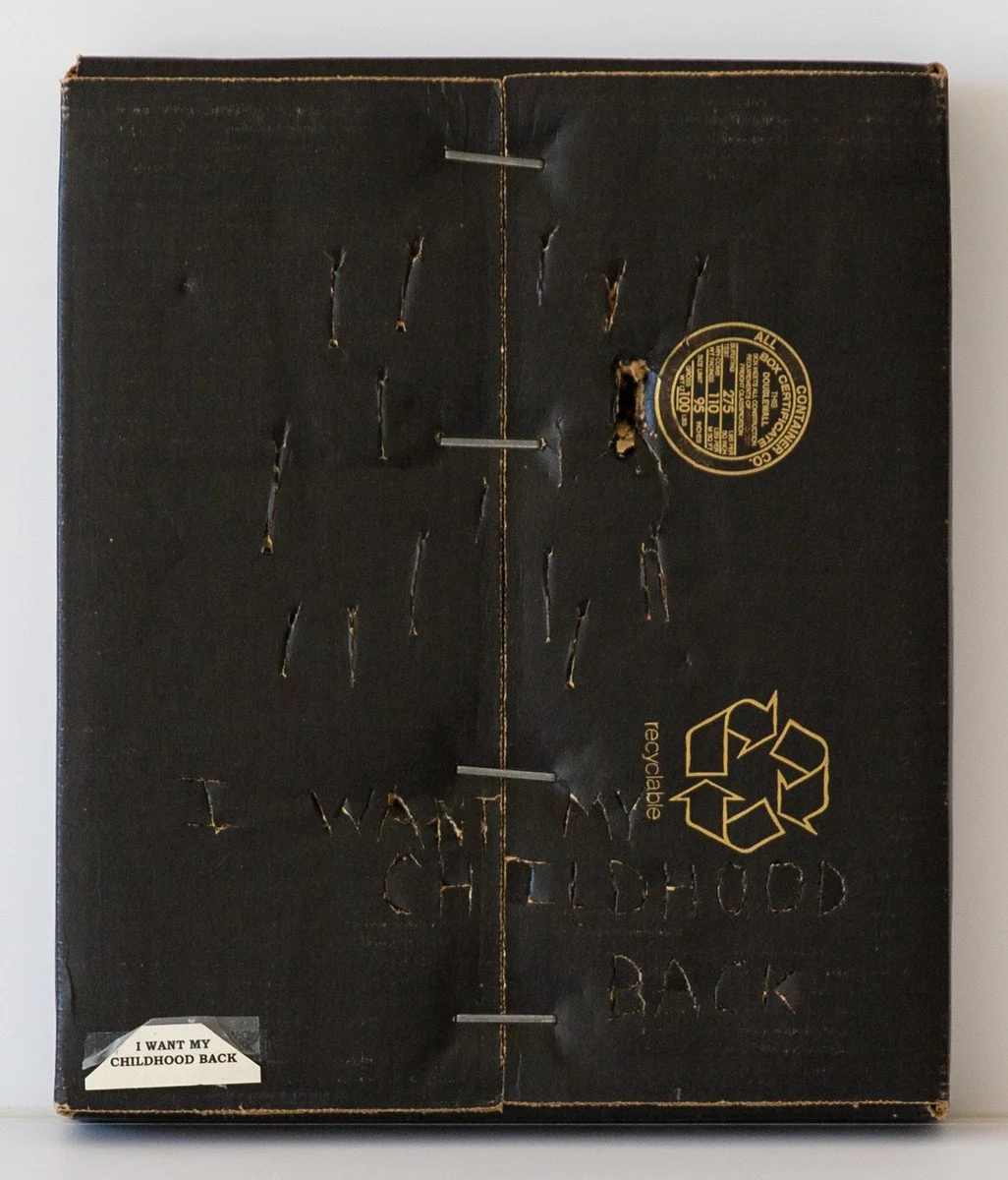 "I Want My Childhood Back" - Anonymous, 
Cardboard, Wood, and Paint on Paper, 1999
