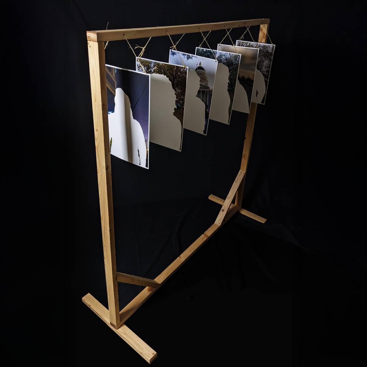 Whited our portraits hanging from a wooden structure.