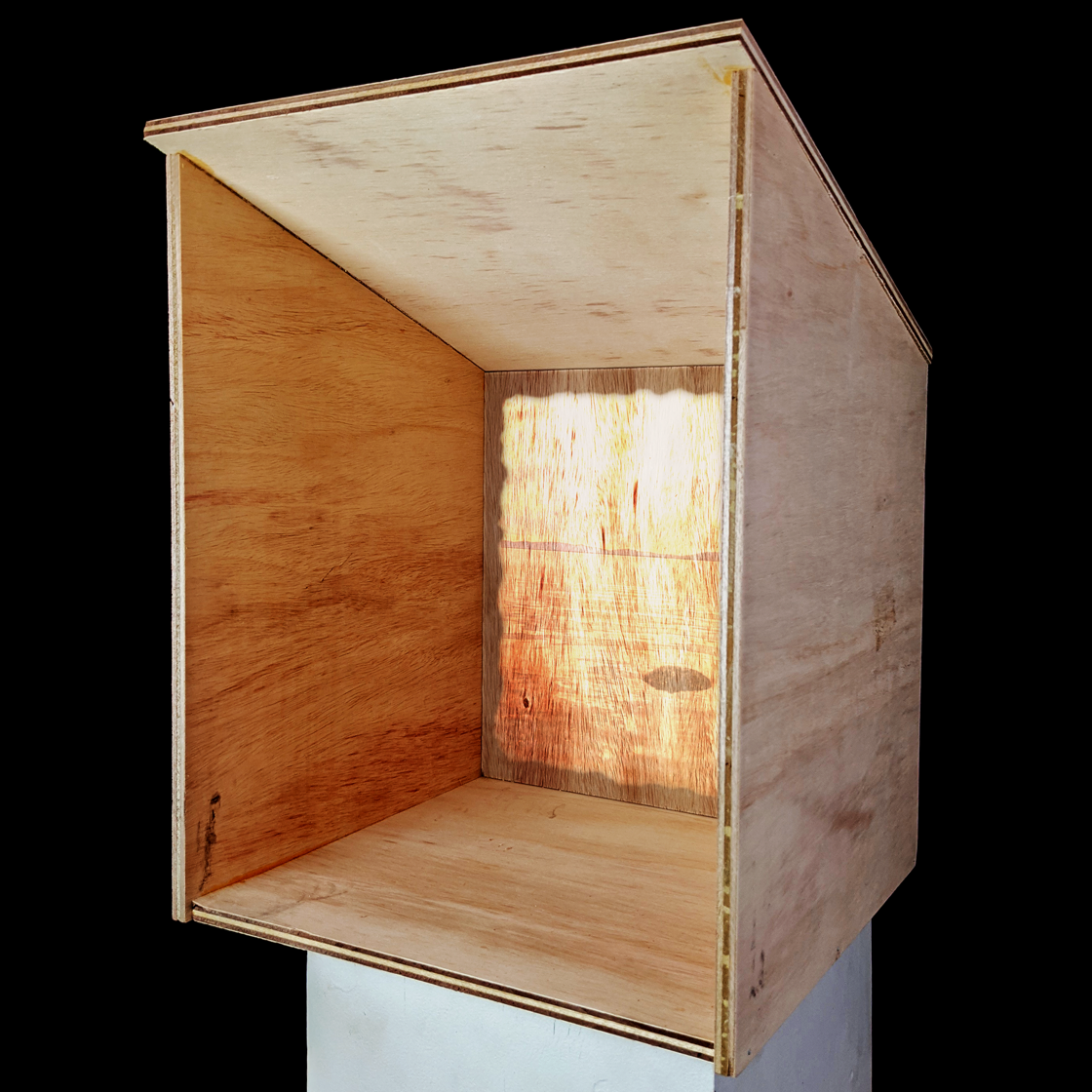 Sculpture made of open wooden box with video projection inside