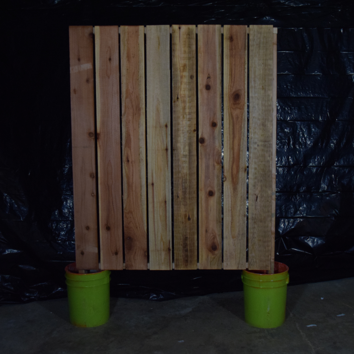 A small section of wall held up by concrete in buckets