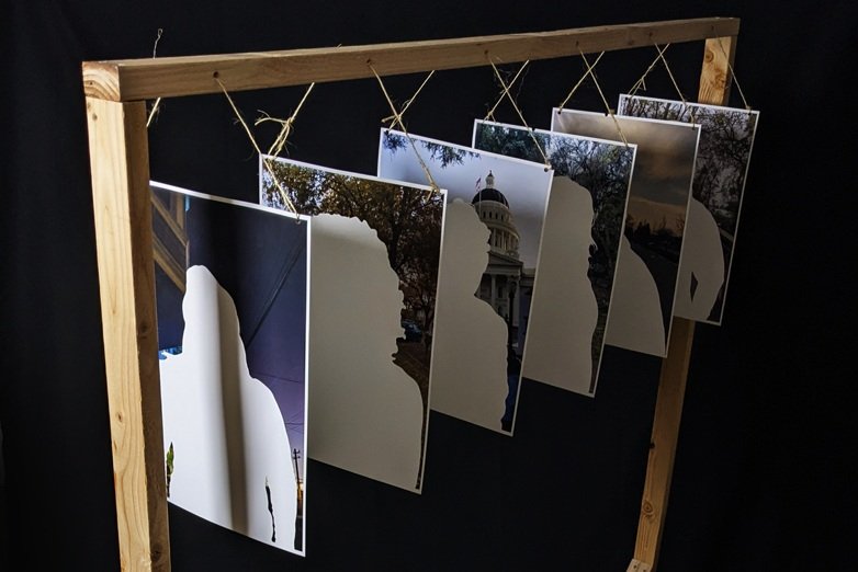 Whited our portraits hanging from a wooden structure.