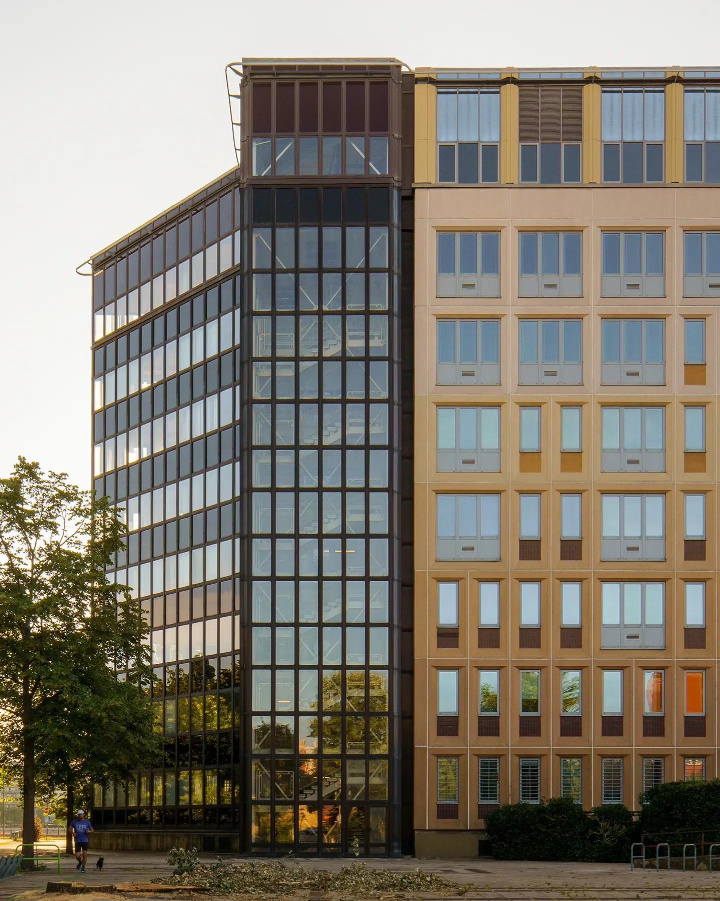 Backlit glass facade of ELTE at Infopark Budapest in morning light, staircase visible, connected to main building