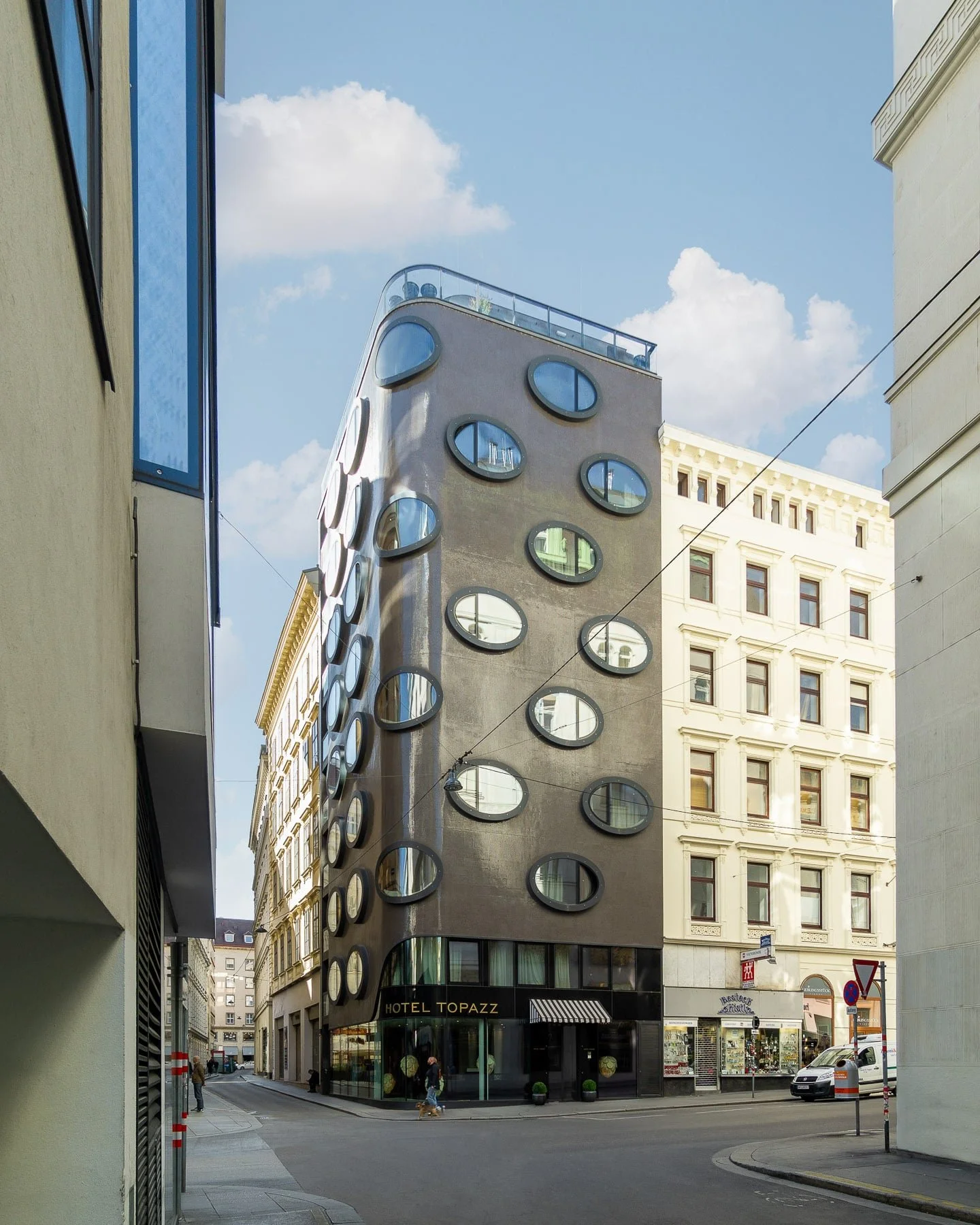 Vienna landmark: Hotel Topazz showcasing its unique, curved design, prominent oval windows, and a modern aesthetic. Boutique hotel architecture in Austria.