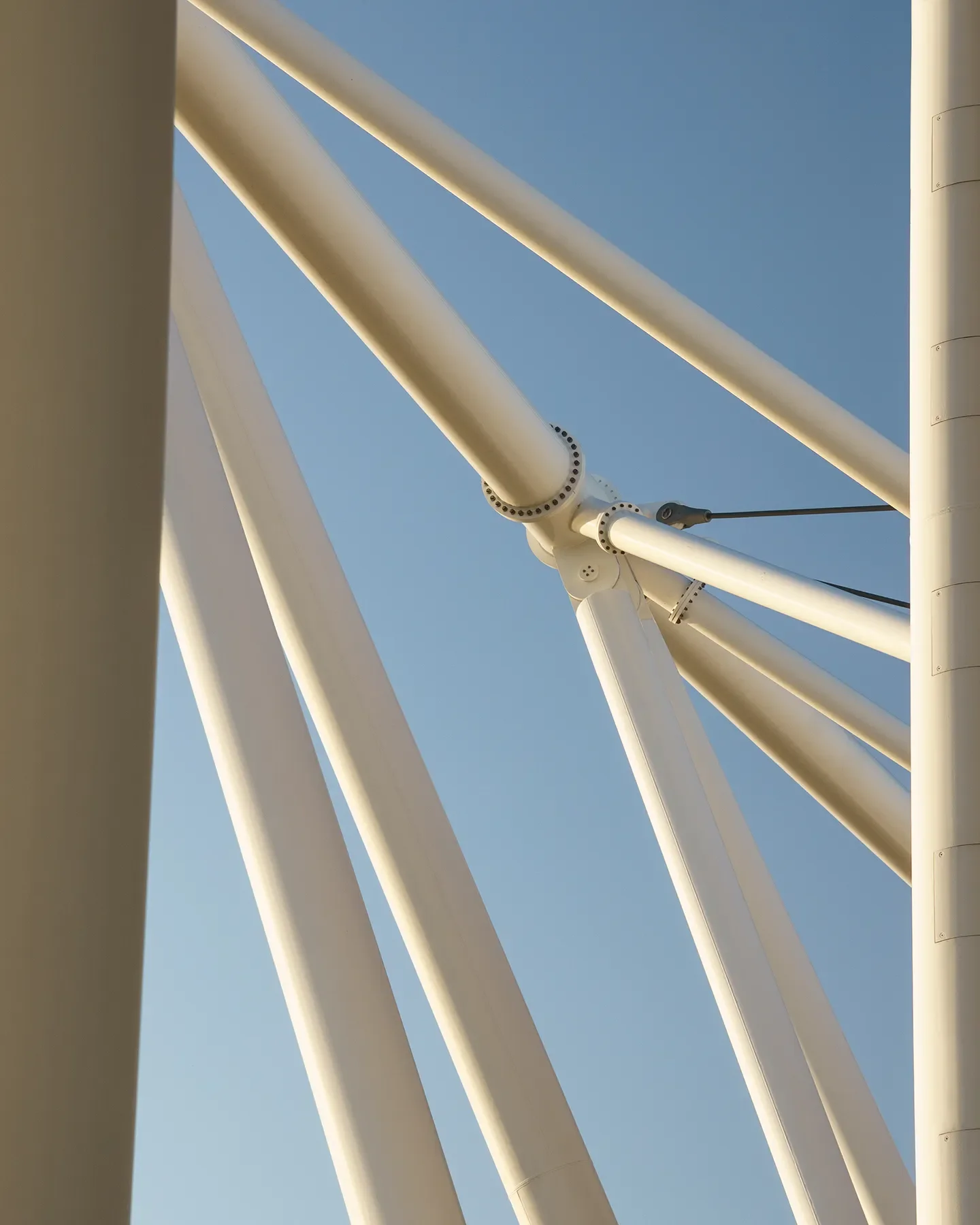 Detailed shot of Budapest Athletics Stadium white metal structures against blue sky with sunset light