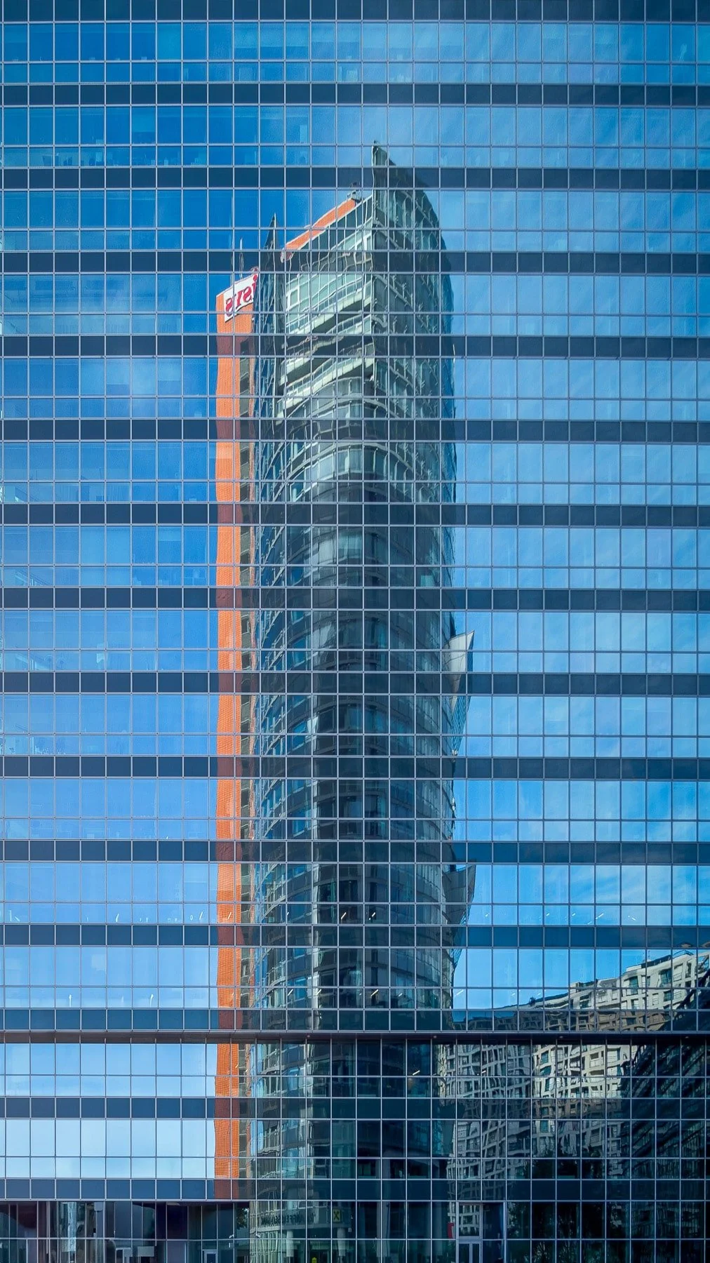Vienna, Austria: Andromeda Tower, a contemporary skyscraper with a striking design, reflected in another building's facade, creating a distorted and abstract view