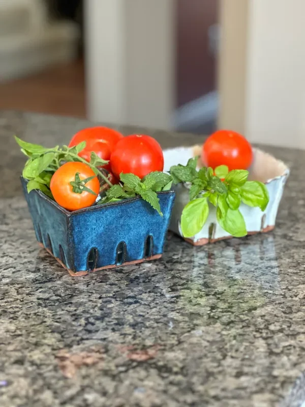 Clay berry baskets holding tomatoes
