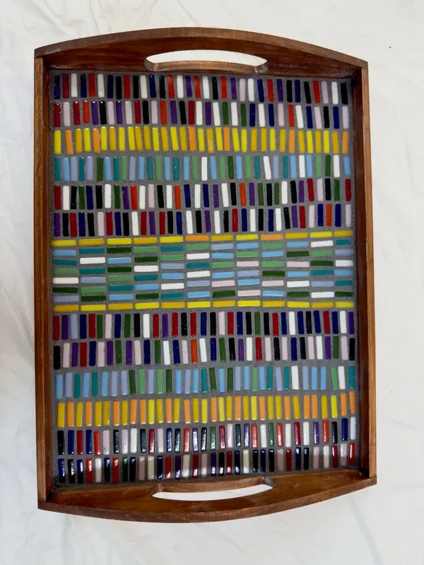 A wooden tray with tiles arranged on it