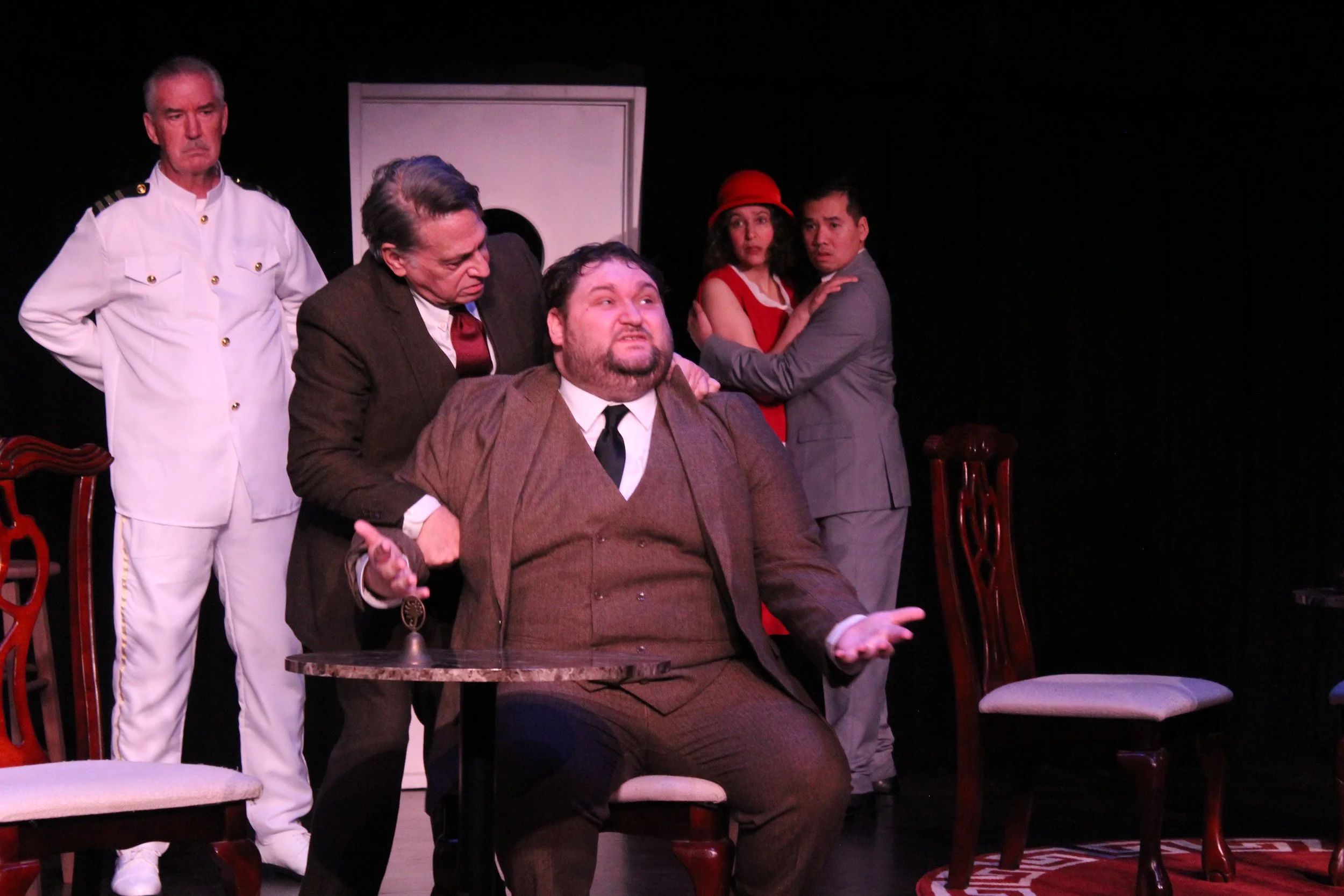 A man being restrained as others look on aghast in the Kentlands Community Players' production of 'Outward Bound'