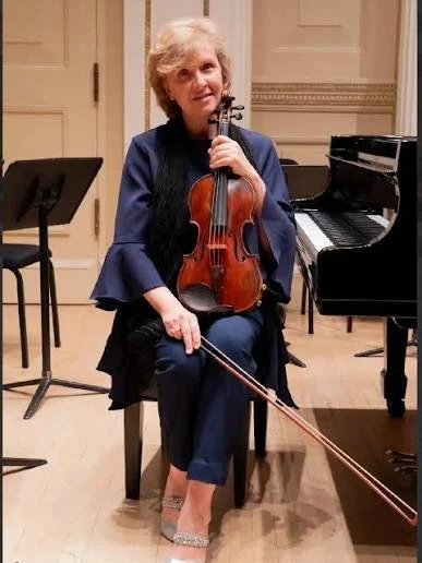 Alessandra Cuffaro seated with her violin