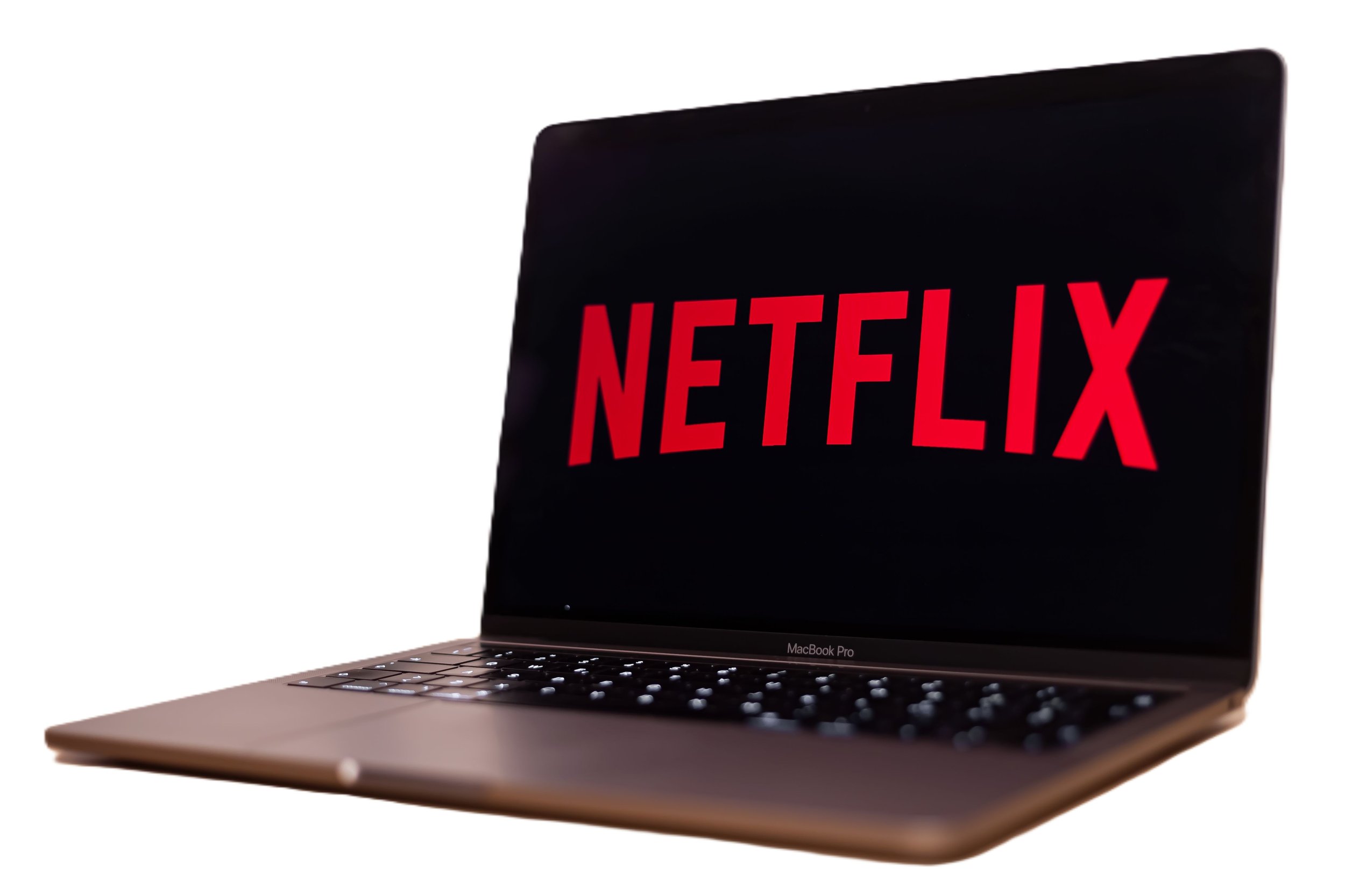 A MacBook Pro laptop with a Netflix logo displayed on the screen.