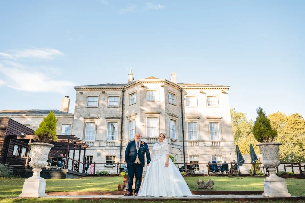 A bride and groom stood a the back of Aston Hall Hotel in South Yorkshire