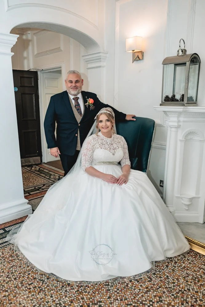 A bride and groom sit elegantly at Aston Hall hotel but the fire place