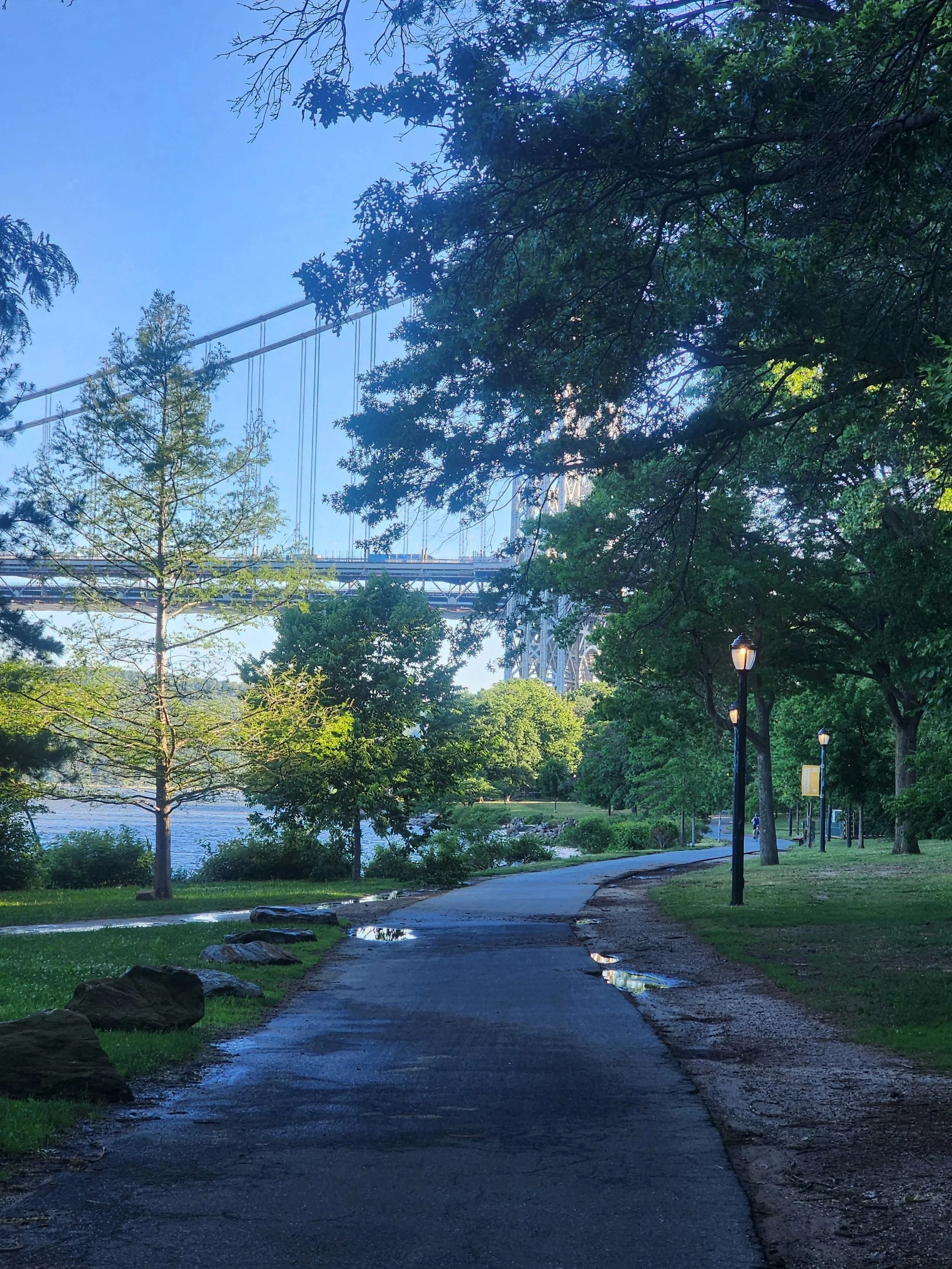 Shady path image of the George Washington Bridge in NYC.