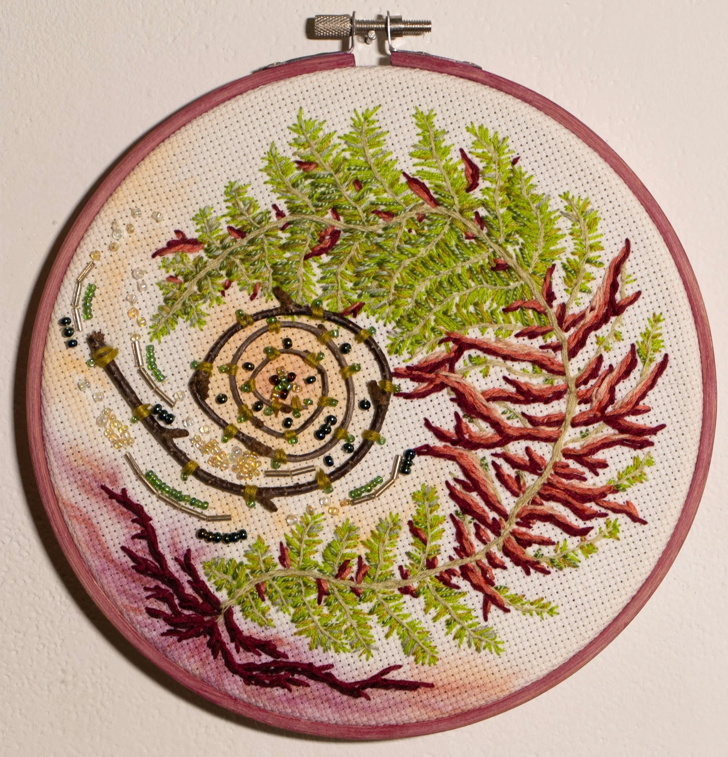 Drifting Off Because I Can’t Pretend to Remember | 2024 | Embroidery Thread, Seed Beads, Found Stick, Watercolor, Cross Stitch Fabric, Embroidery Hoop | 7.5" x 7.25"