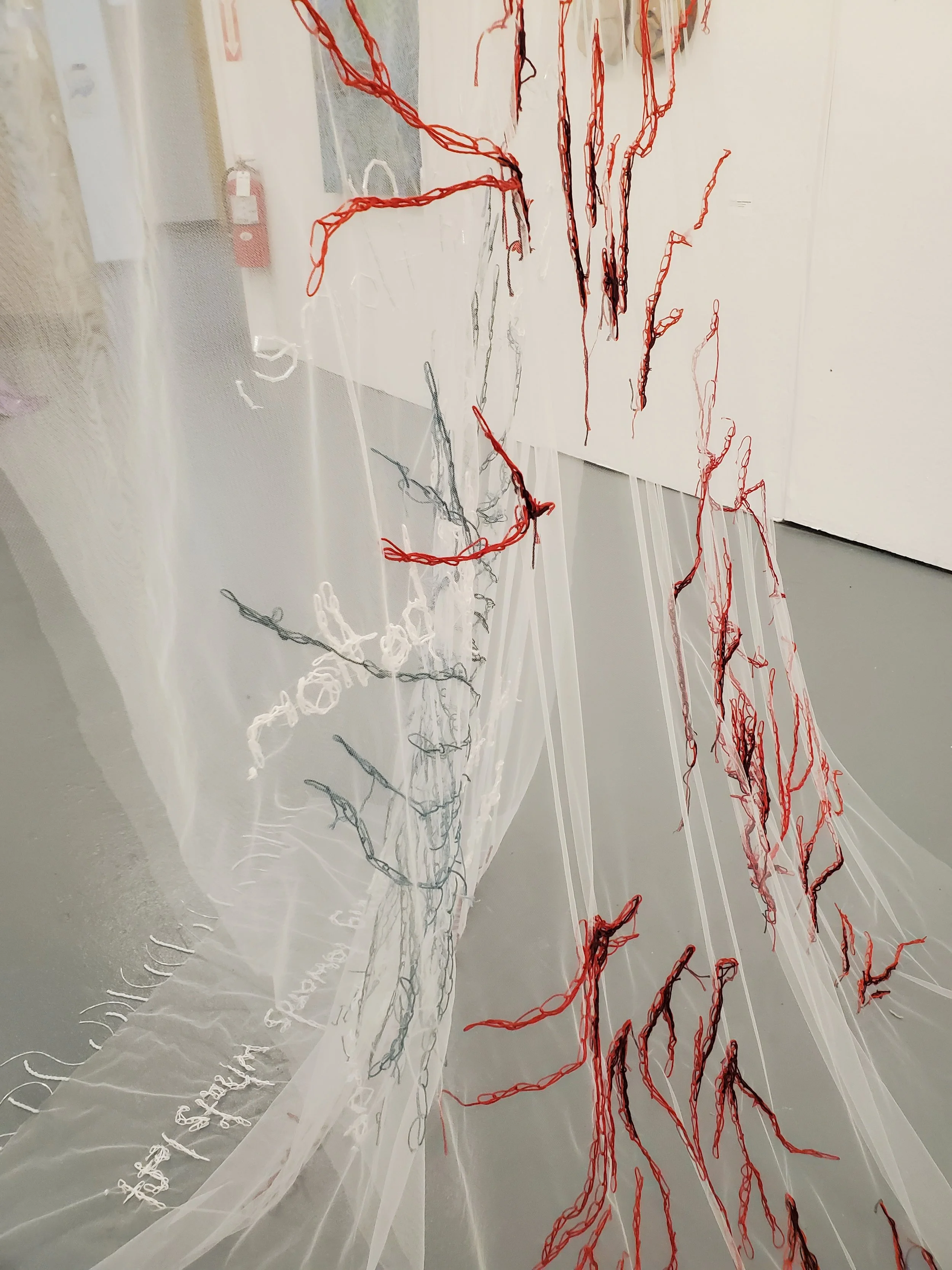 The Schism of Being Submerged | 2024-25 | Tulle, Embroidery Thread, Seed Beads, Found Branch, Fishing Wire, Oil Paint | 102" x 65" x 61"