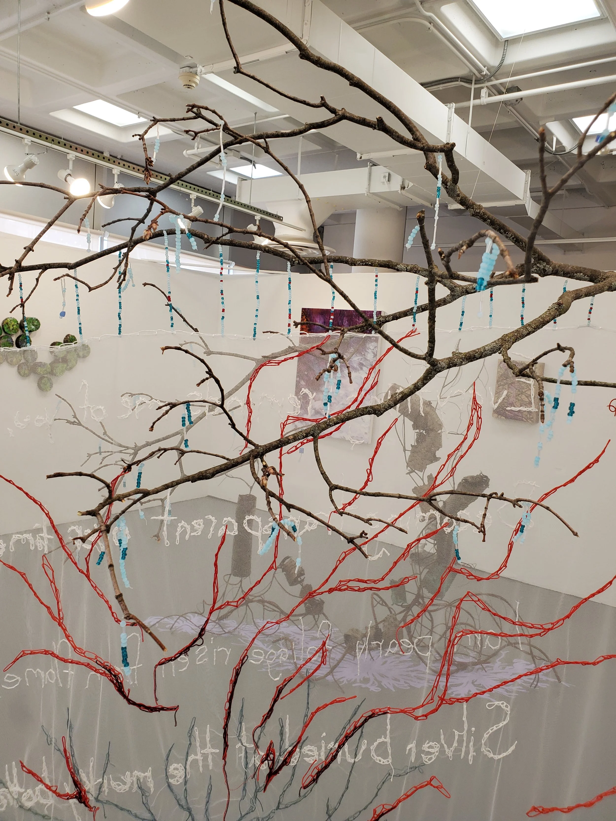 The Schism of Being Submerged | 2024-25 | Tulle, Embroidery Thread, Seed Beads, Found Branch, Fishing Wire, Oil Paint | 102" x 65" x 61"