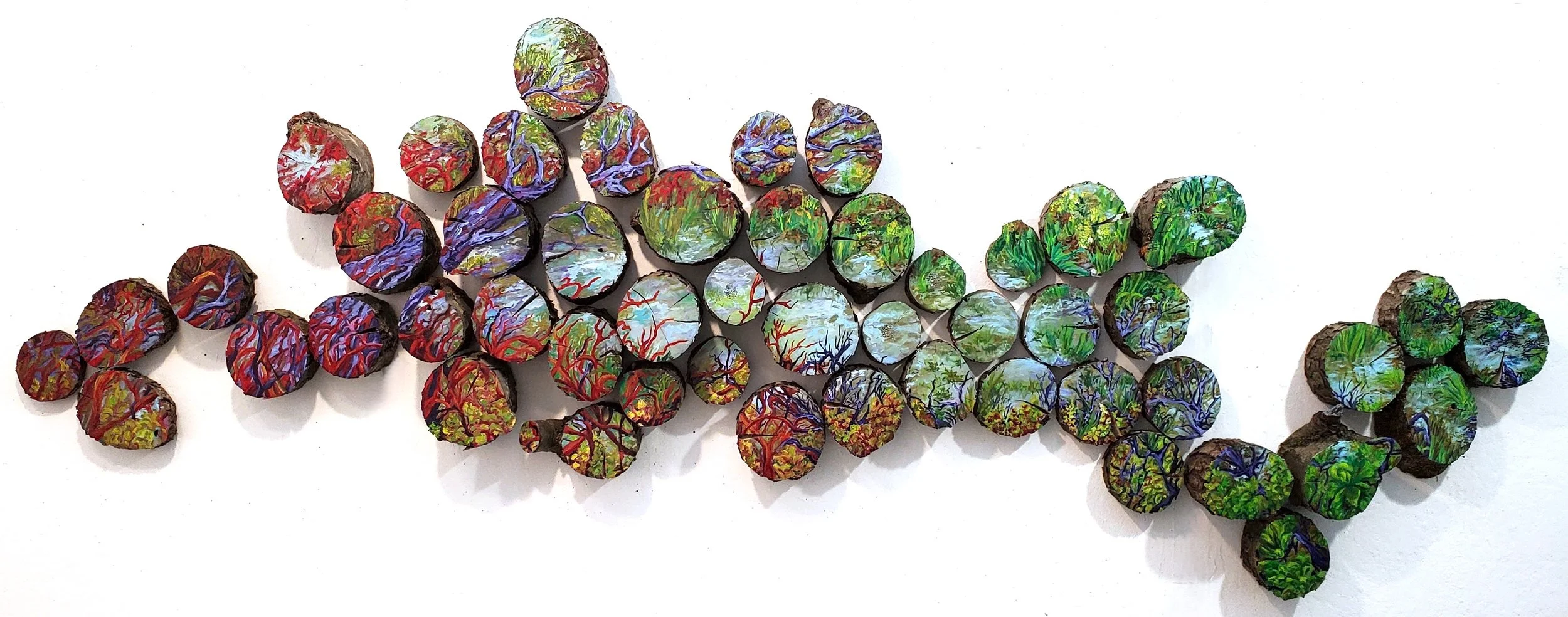  Murky Depths Seep Out | 2025 | Oil on Tree Trunk Cross Sections | 98 x 32 x 4.5 inches | 52 Pieces
