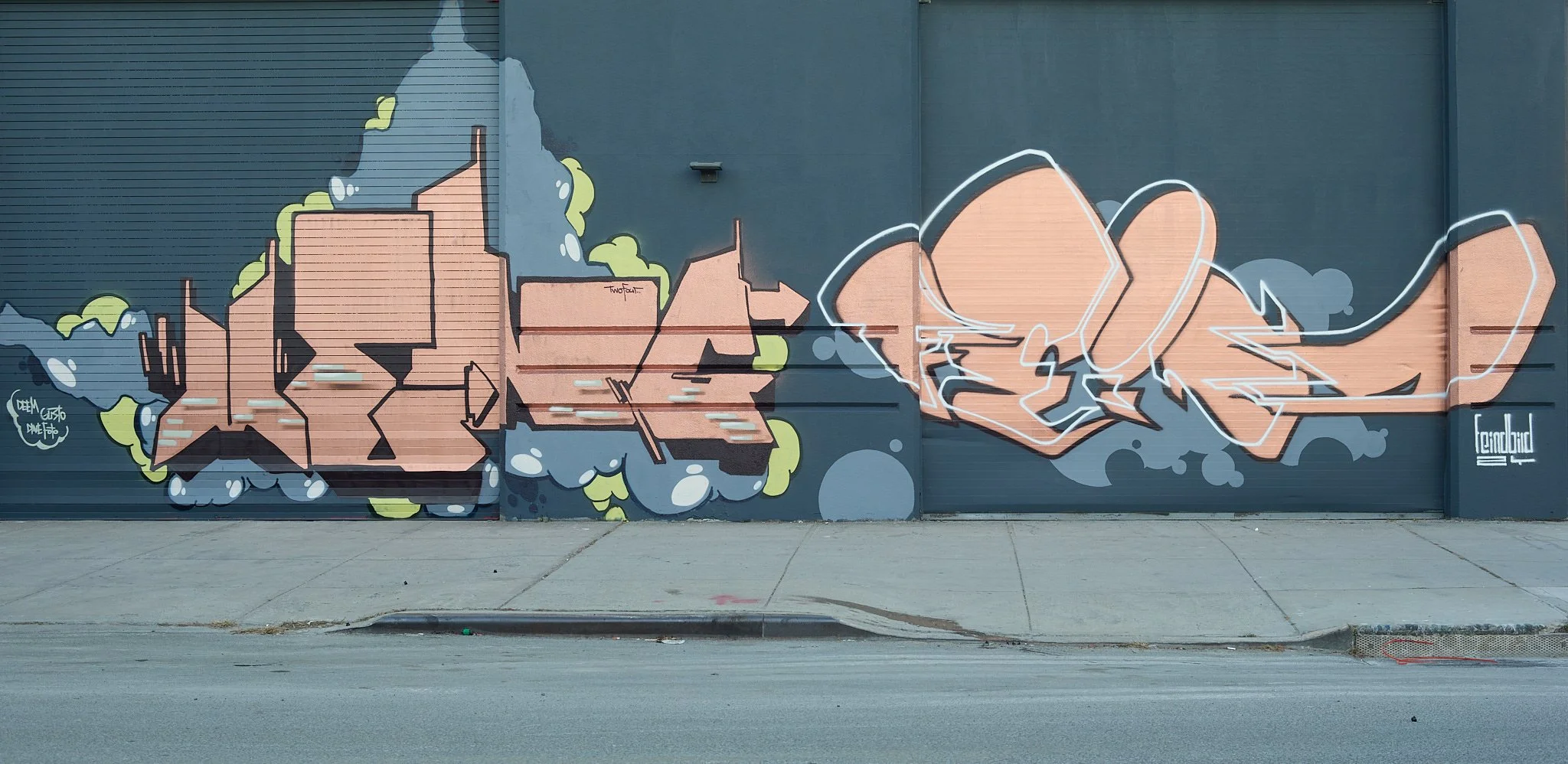 mettalic graffiti art on smooth gray wall