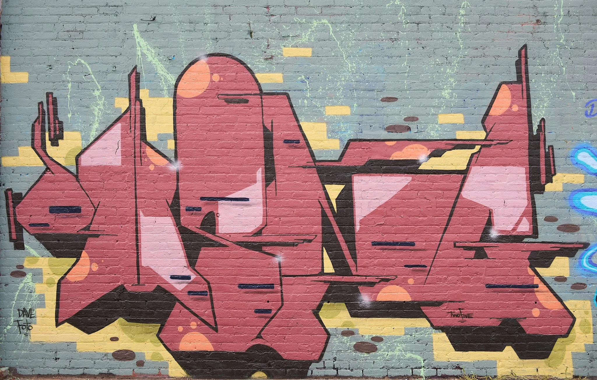 colorful graffiti lettering art on grey brick wall